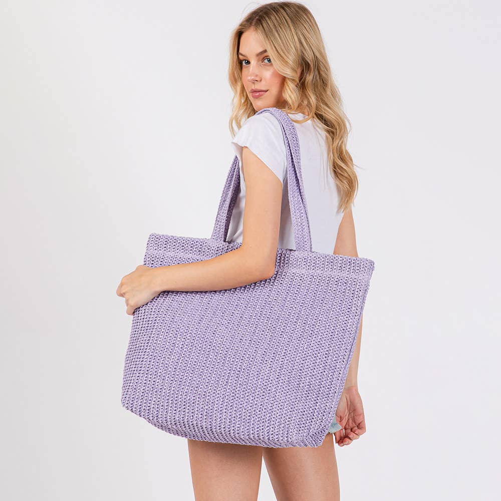 Handmade crochet straw tote bag with sturdy handles, perfect for beach or casual outings, from private label.