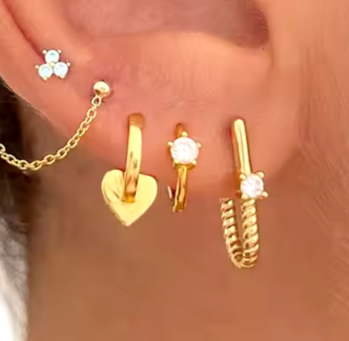 Roped In huggie hoop earrings in steel with 14K gold finish, showcasing a textured design and elegant hoop shape.