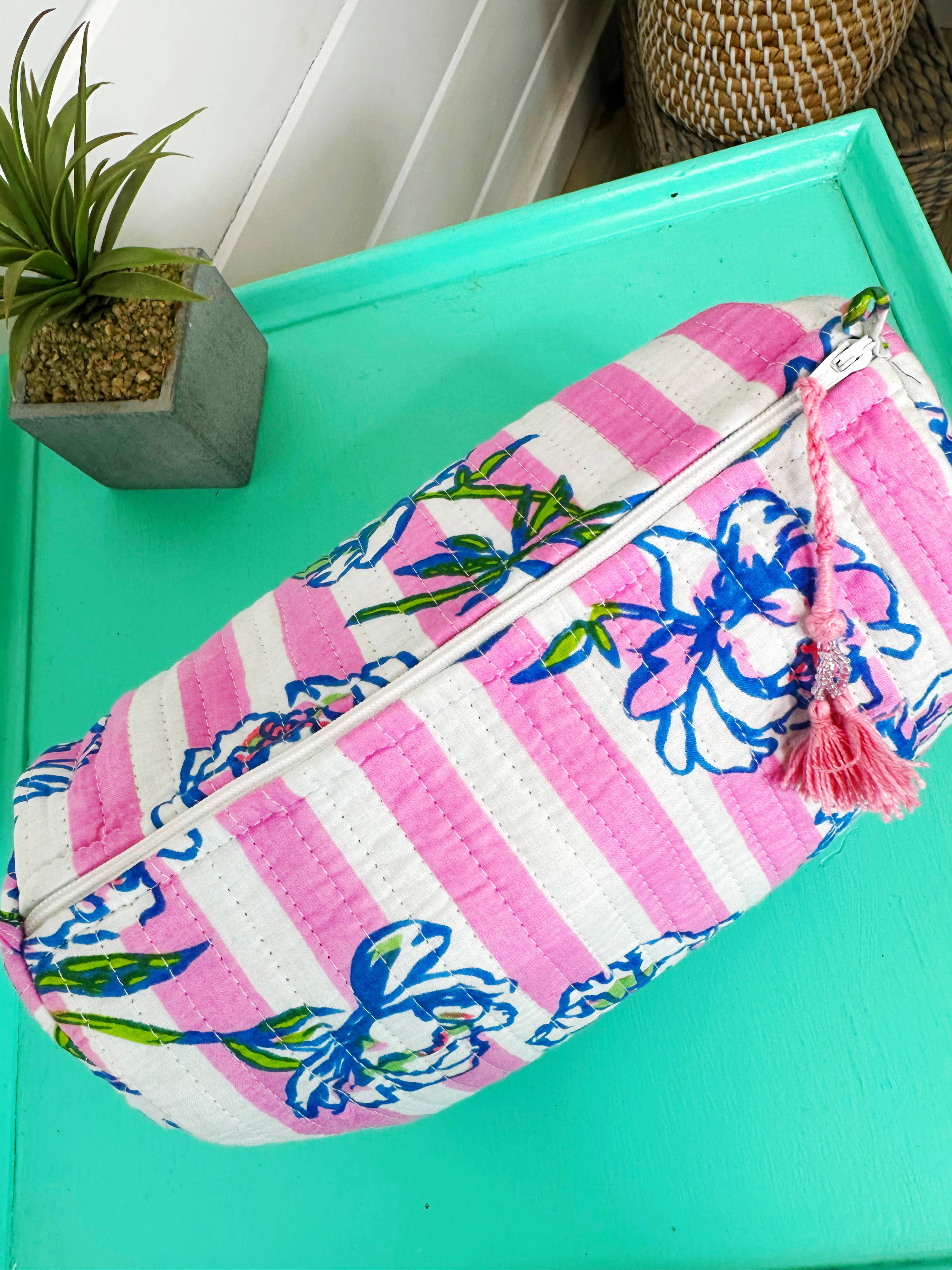 Quilted makeup pouch in peony pink stripe by Folklore Couture, showcasing a stylish and functional design for cosmetics.
