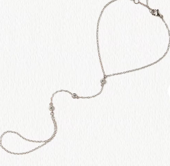 Hand chain by HoopLa featuring a steel design with crystal accents and a ring attachment for elegant style.