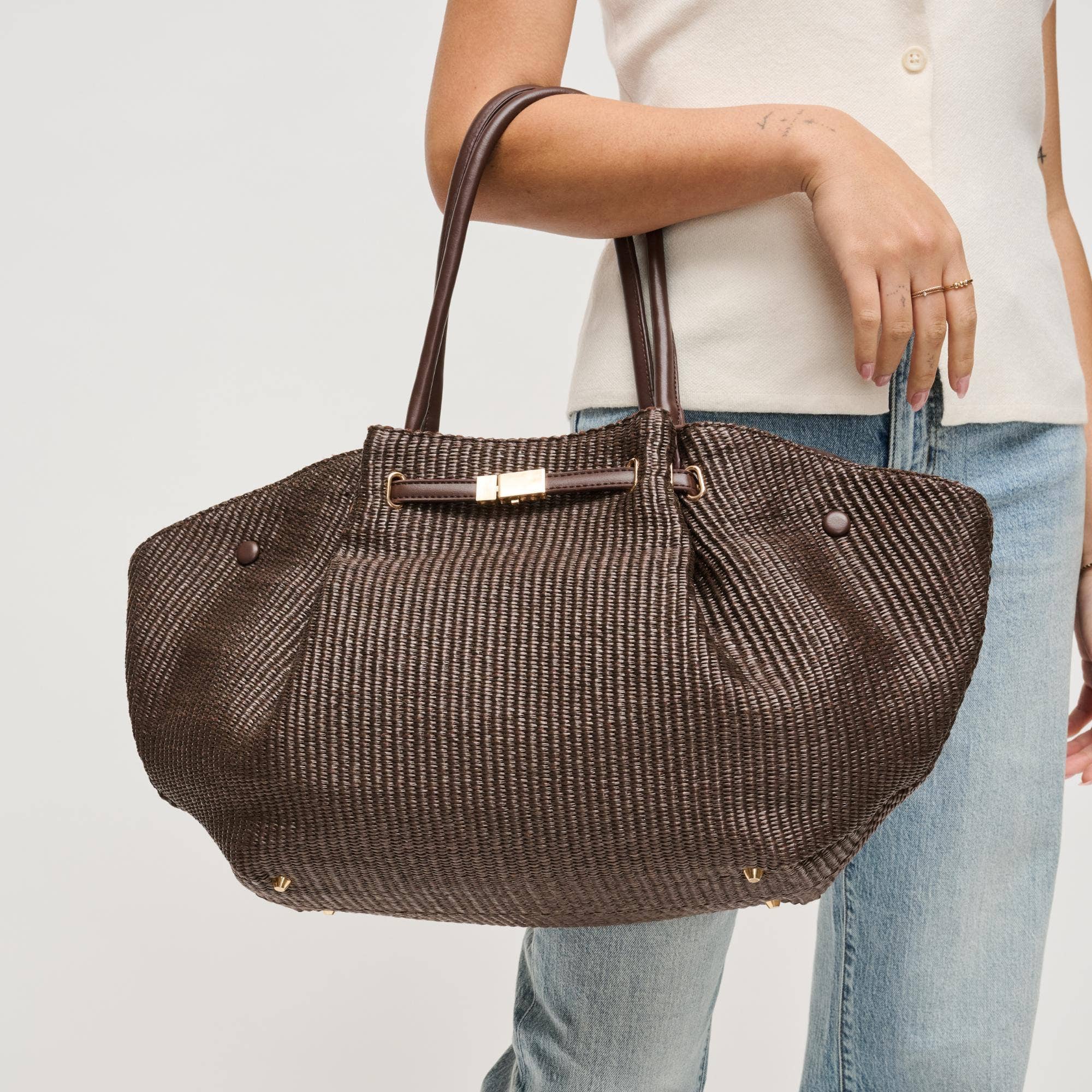 Urban Expressions Kaia straw tote with woven texture and sturdy handles, ideal for casual outings and beach trips.