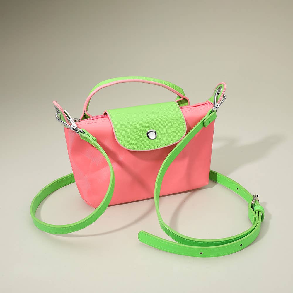 Private label compact two-tone handbag with crossbody strap, featuring stylish design and modern accessory details.