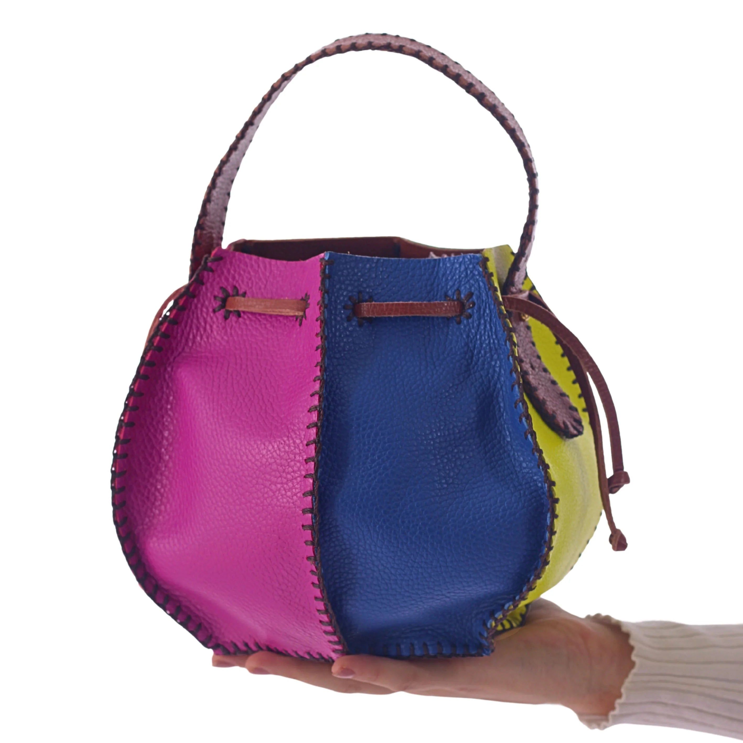 Carlos Falchi tall bucket bag with sleek design and sturdy handle, made of high-quality material, shown in a close-up image.