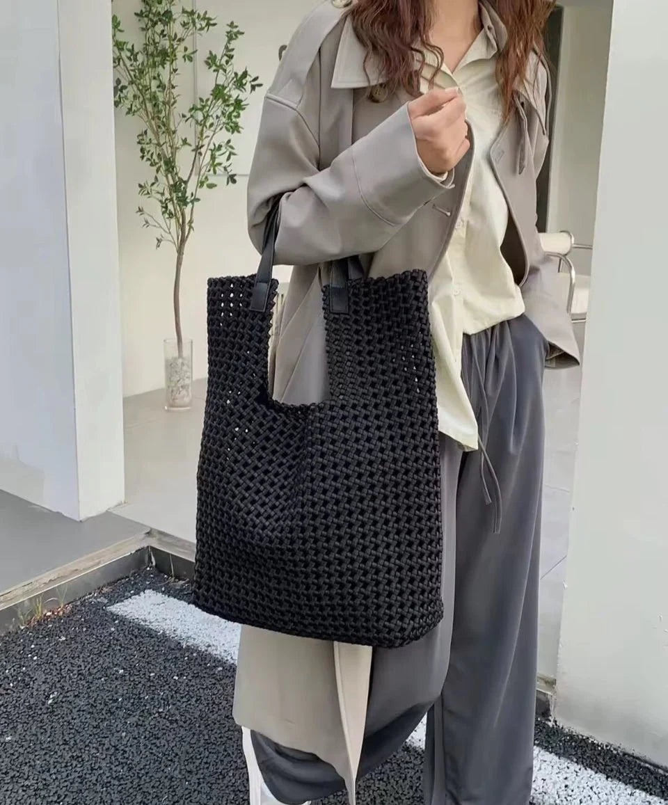 Black Eston woven tote handbag by Prenelove with sturdy woven handles and spacious interior, perfect for everyday use.
