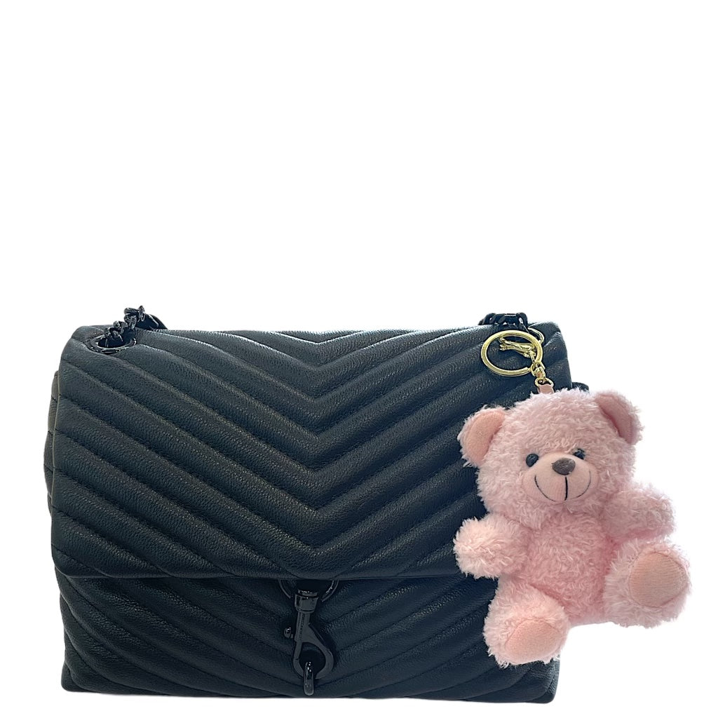 Plush teddy bear keychain hanging from a backpack, featuring soft fur and a cute smiling face.