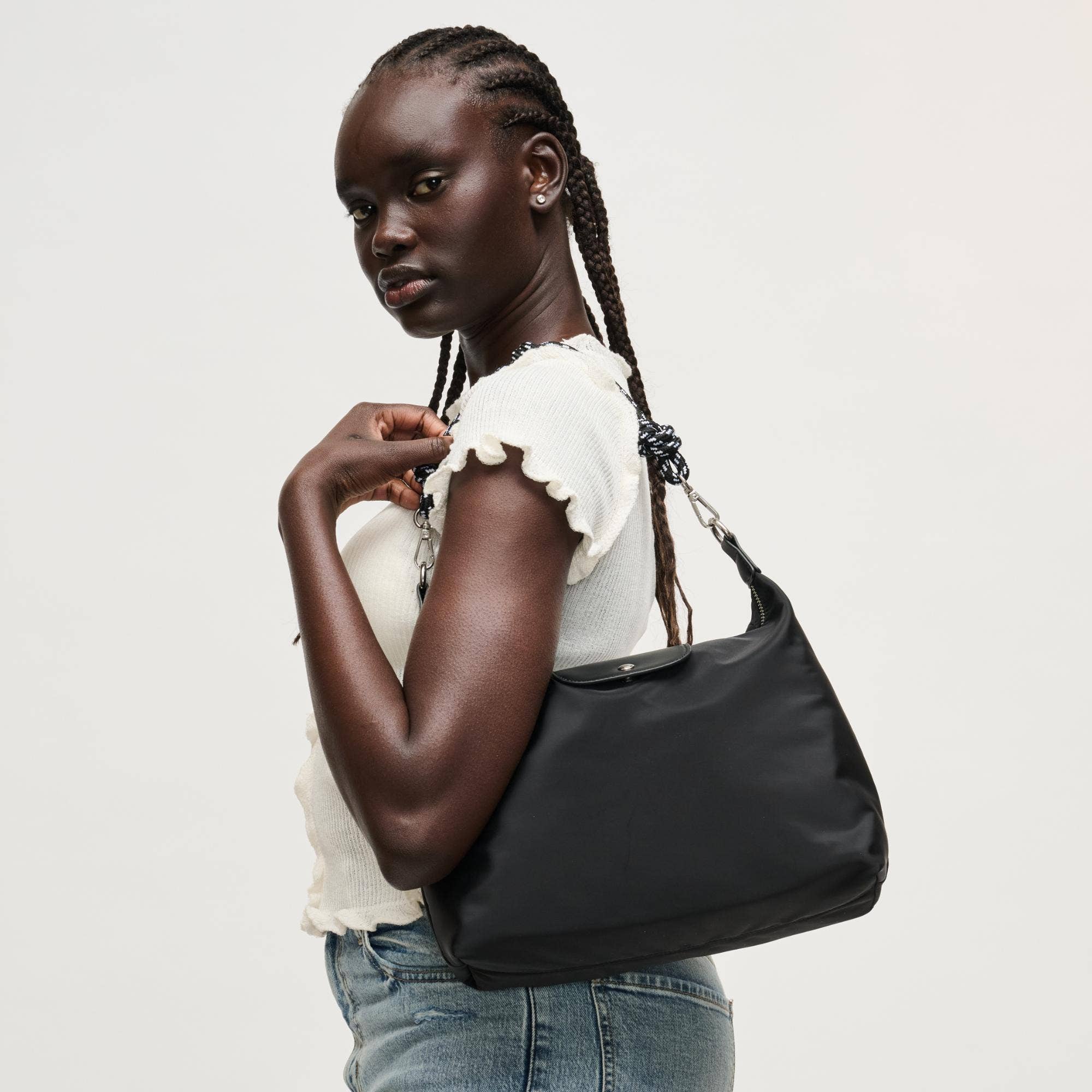 Urban Expressions Nova Hobo bag with adjustable strap and textured leather finish, shown with open top and spacious interior.