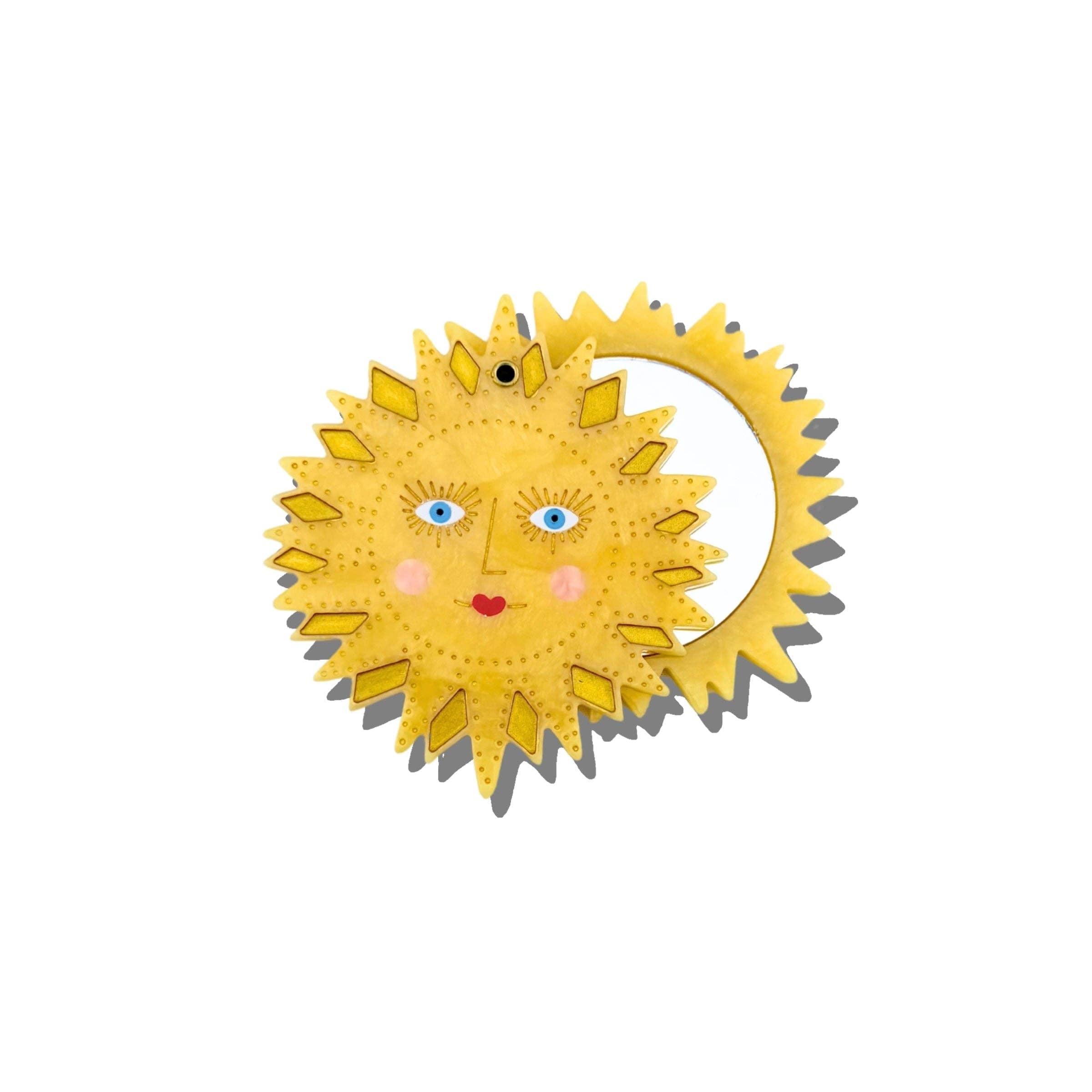 Decorative sun-shaped object with facial features on a white background