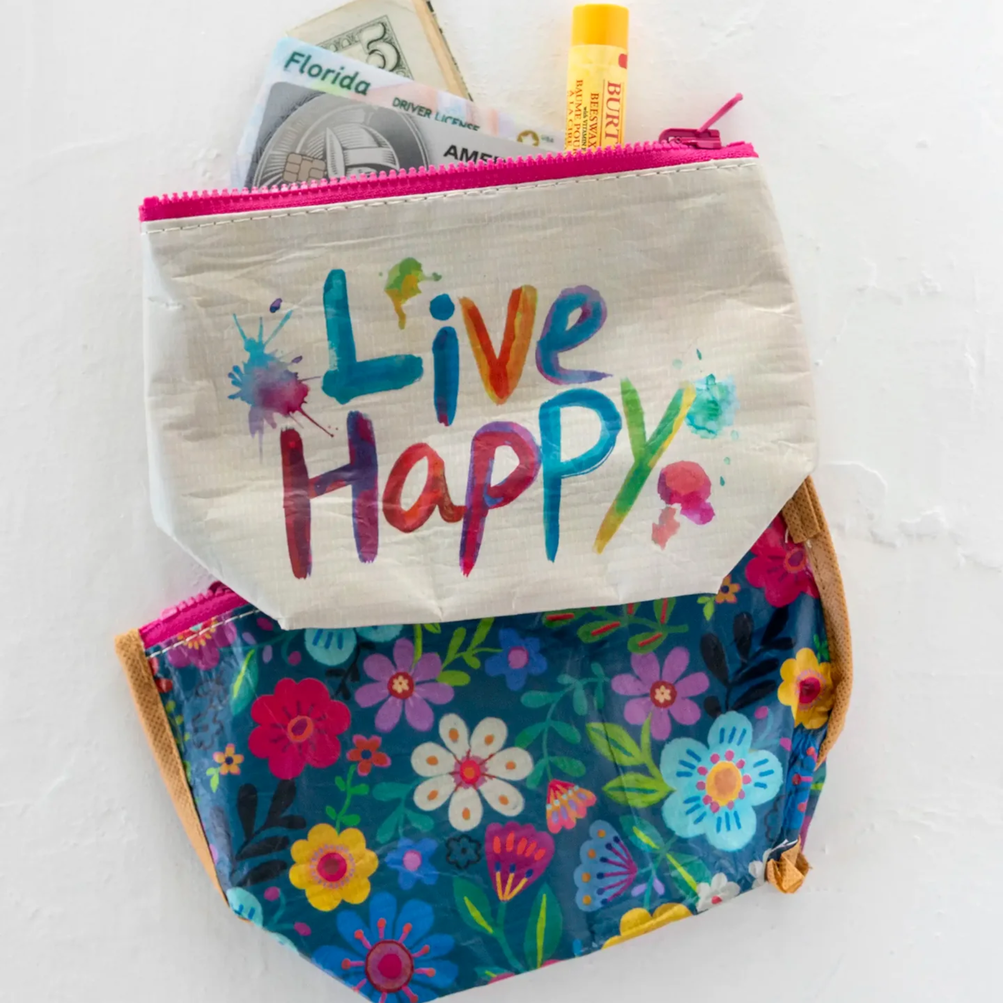 Small recycled reversible zipper travel pouch by Natural Life, featuring eco-friendly materials and vibrant reversible design.
