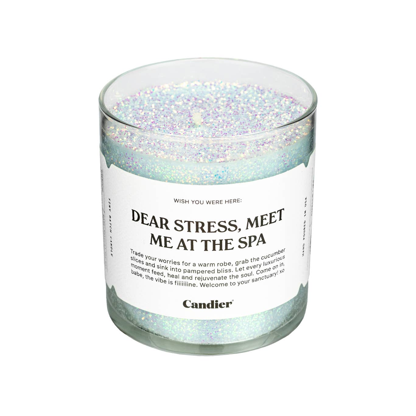 Candier Meet Me At The Spa candle with a sleek glass container and a lit wick, emitting a calming, spa-inspired fragrance.