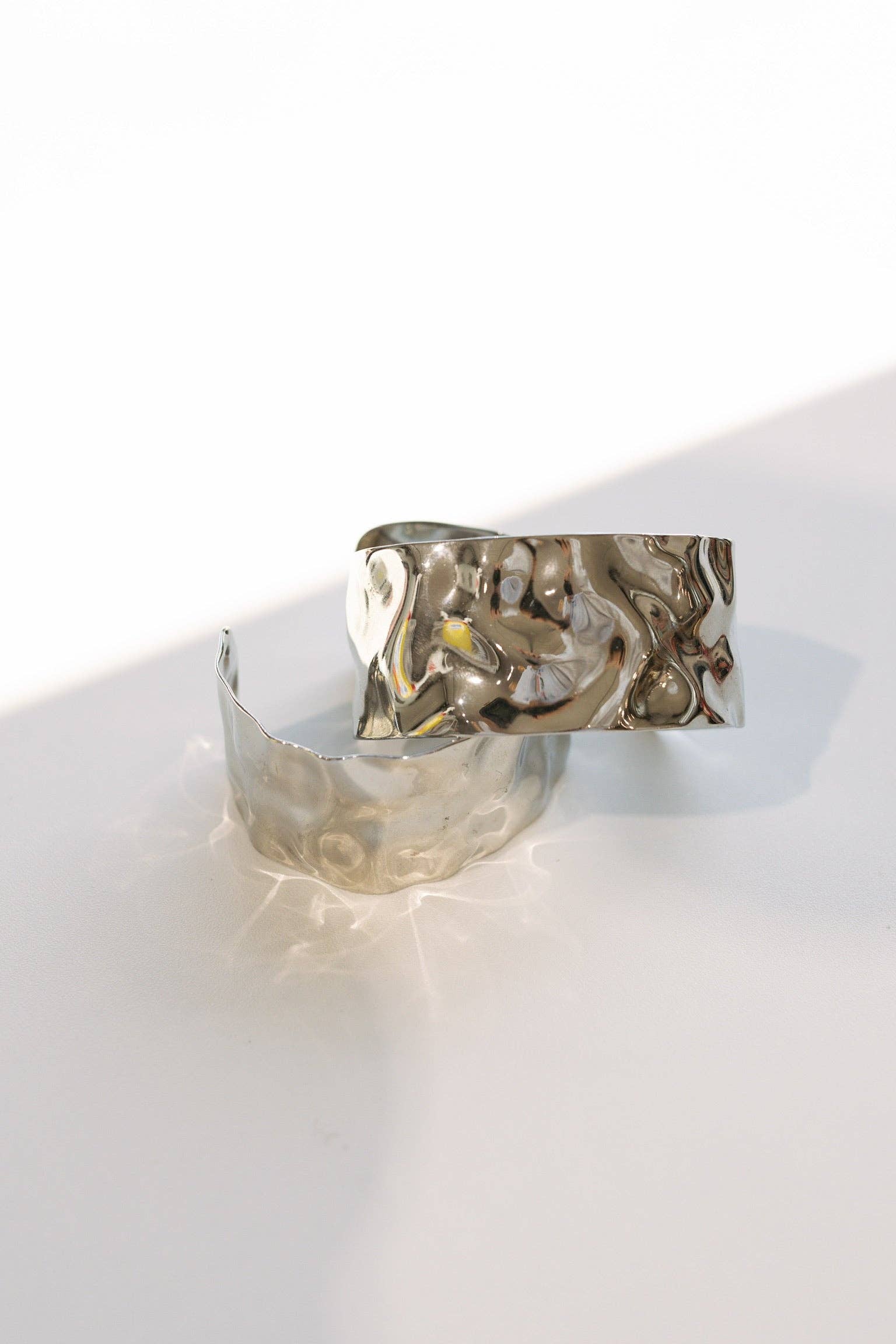 BELJOY Billie Wave gold and silver cuff bracelet with wavy design, featuring sleek metallic finish on a white background.
