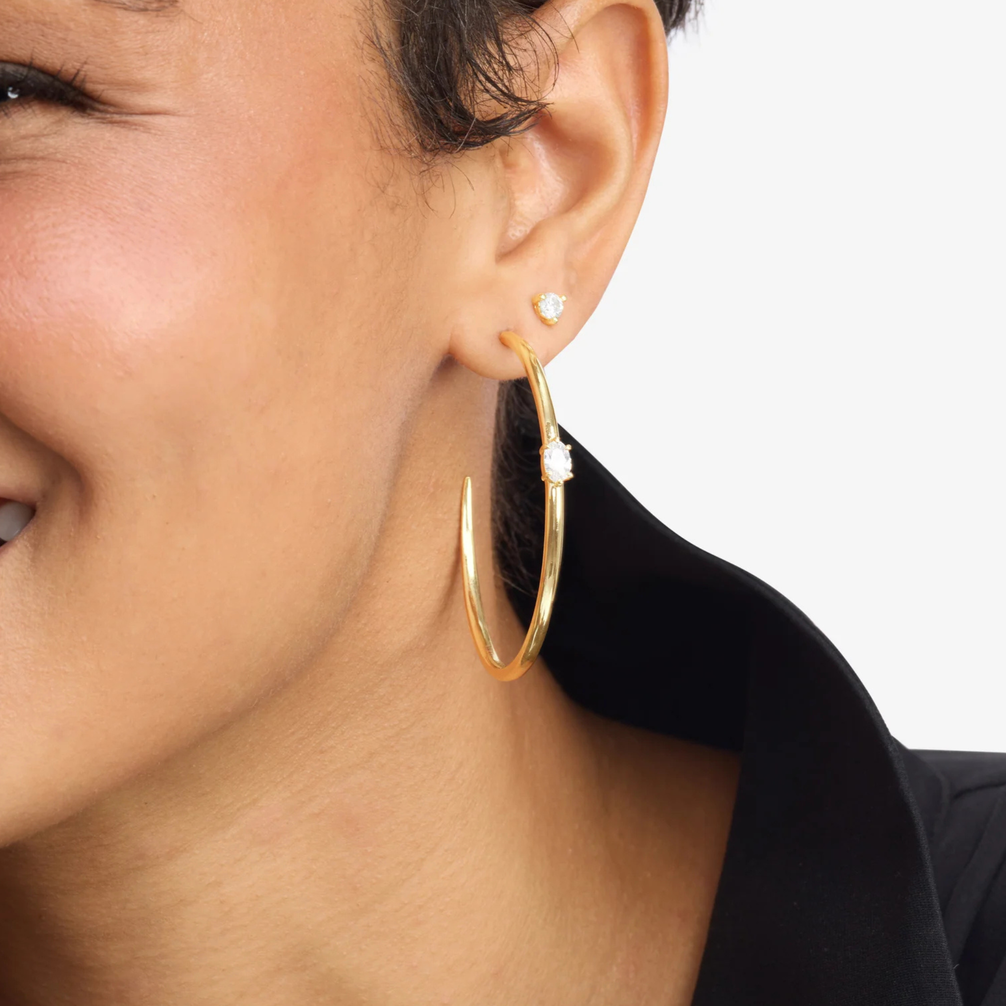 Melinda Maria She's on Point Hoops 2-inch silver earrings with a sleek, modern design for stylish wear.