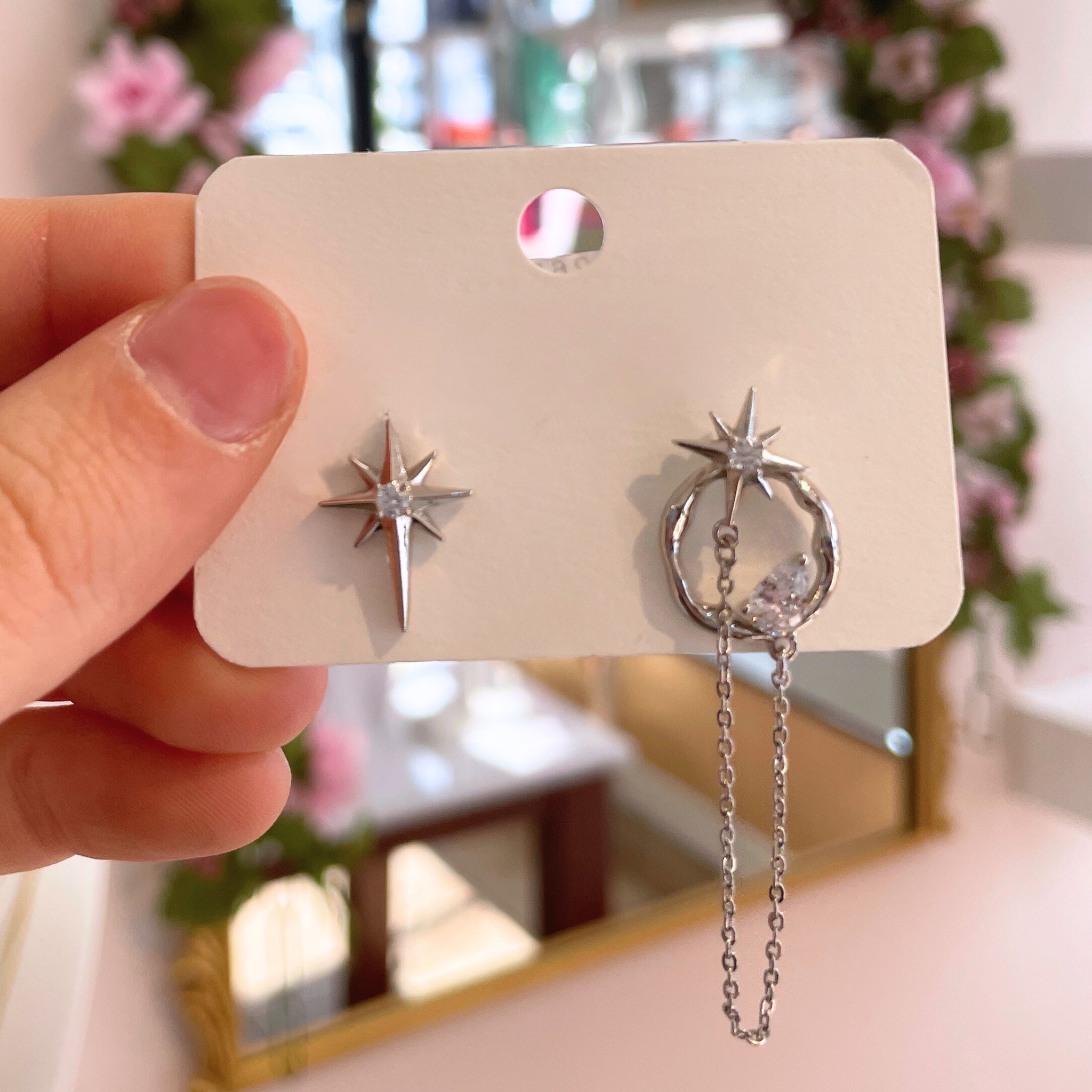 Celestial Starburst Chain Studs earrings featuring a unique starburst design and delicate chain accents.