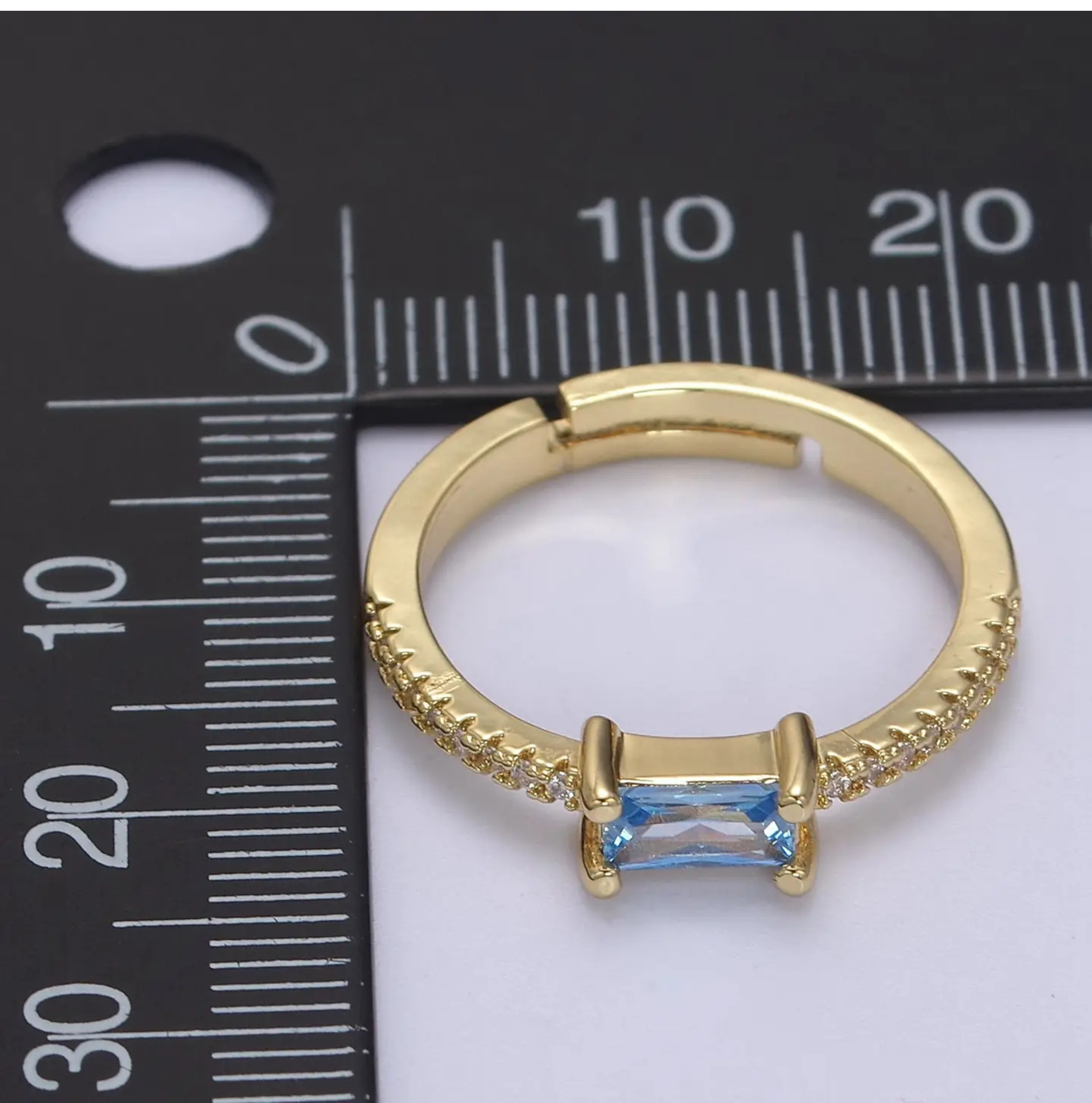 Dainty blue baguette ring in 24K gold filled by Private Vendor, showcasing elegant design and vibrant gemstone detail.