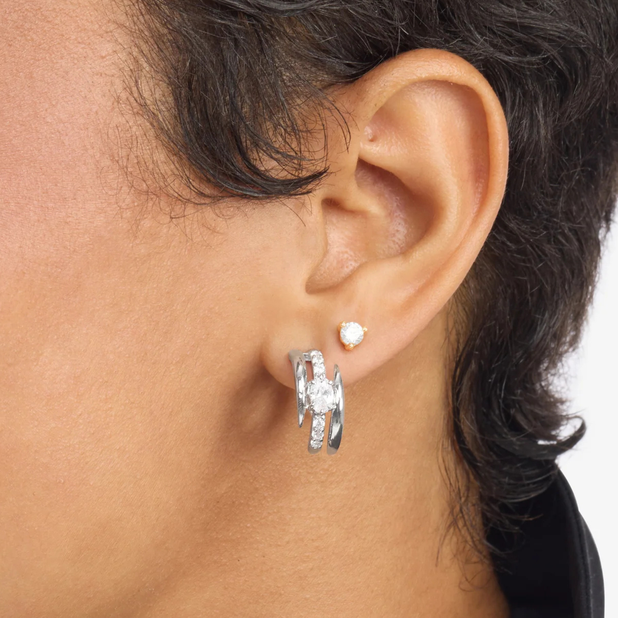 Pair of Melinda Maria She's on Point Pavé Lasso Huggies earrings with sparkling pavé stones and a delicate lasso design.