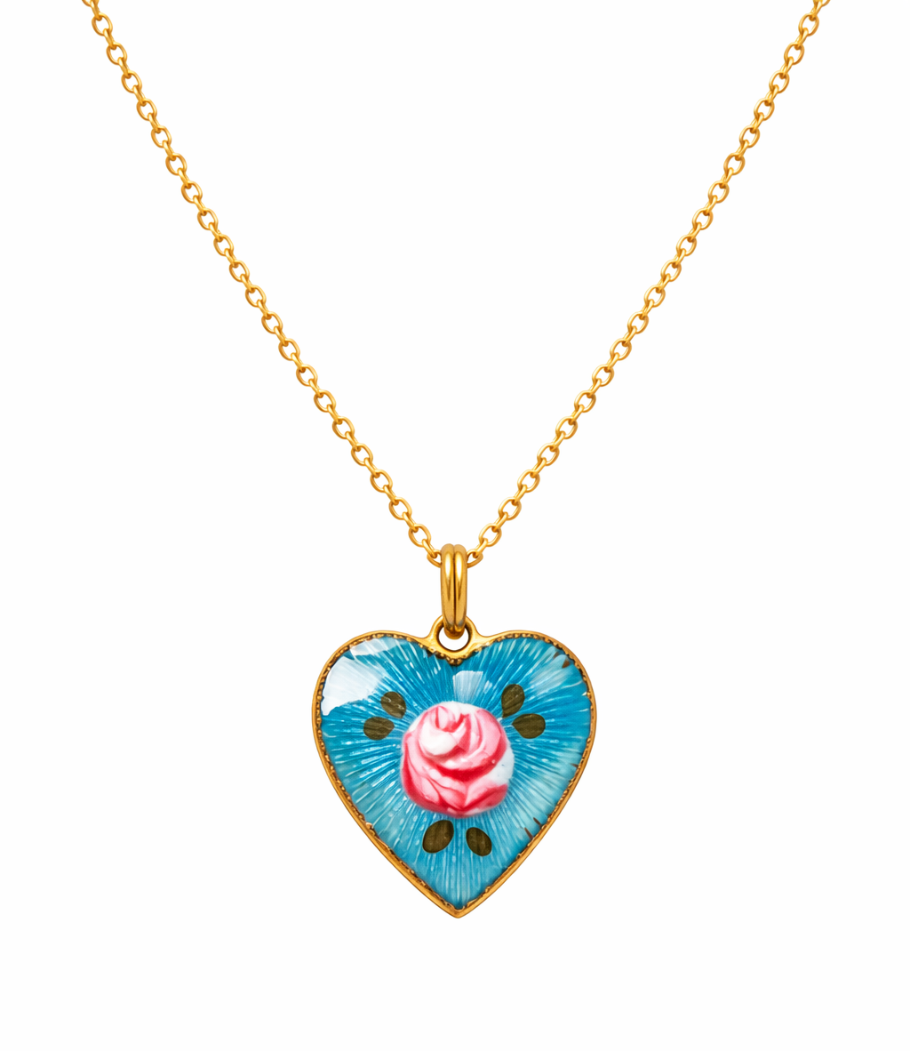 Heart-shaped pendant with a pink rose design on a gold chain against a white background