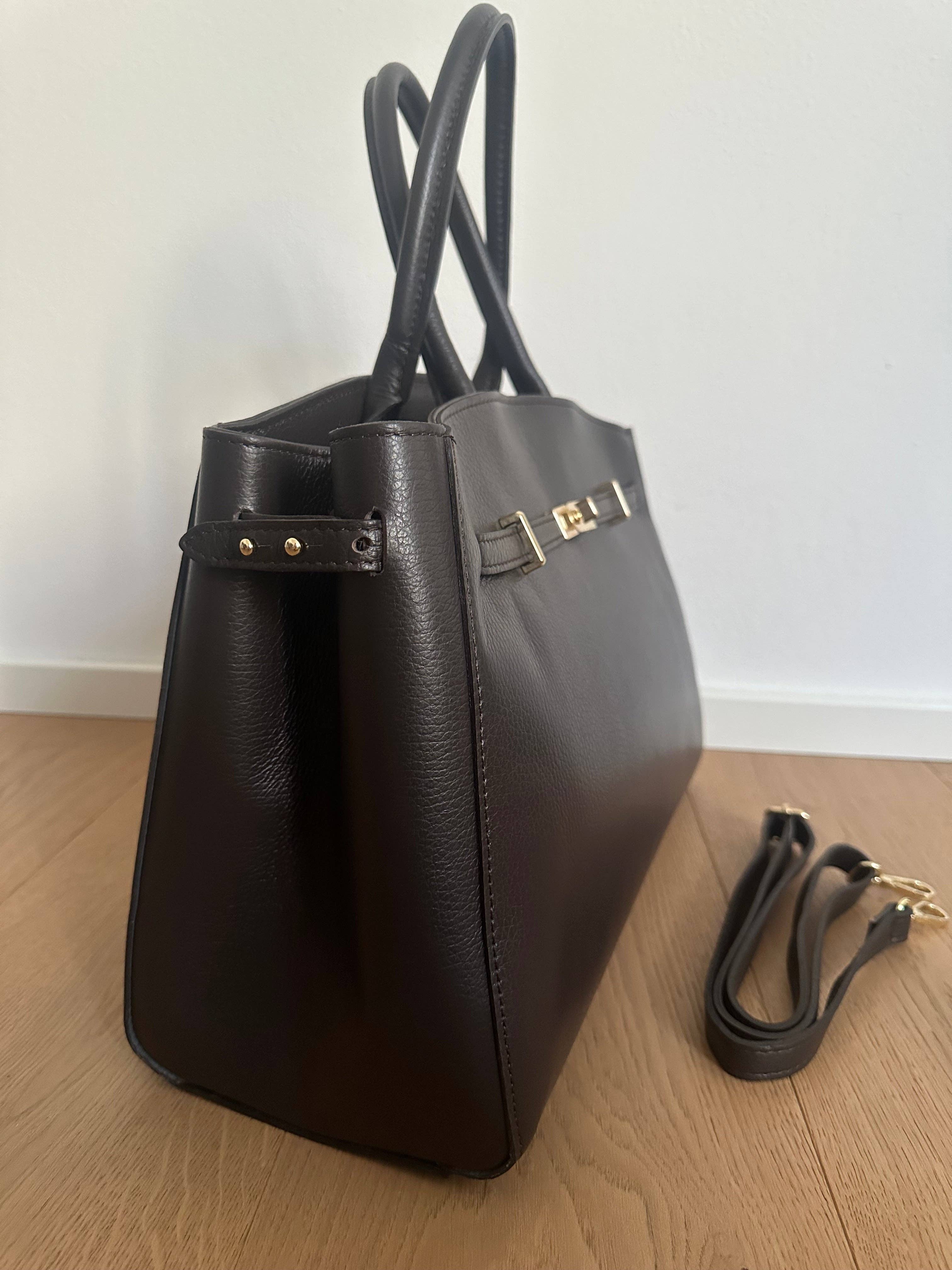 Genuine leather Amelia Big handbag by Private Label with sleek design and sturdy handles, shown in a stylish close-up.