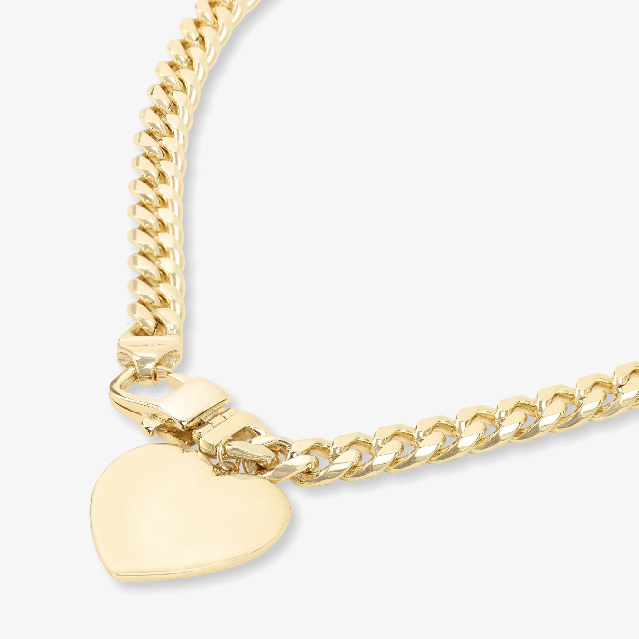 Melinda Maria Julian XL Heart Cuban Chain Necklace in gold, 6.8mm thick, featuring a bold heart pendant on a shiny chain.