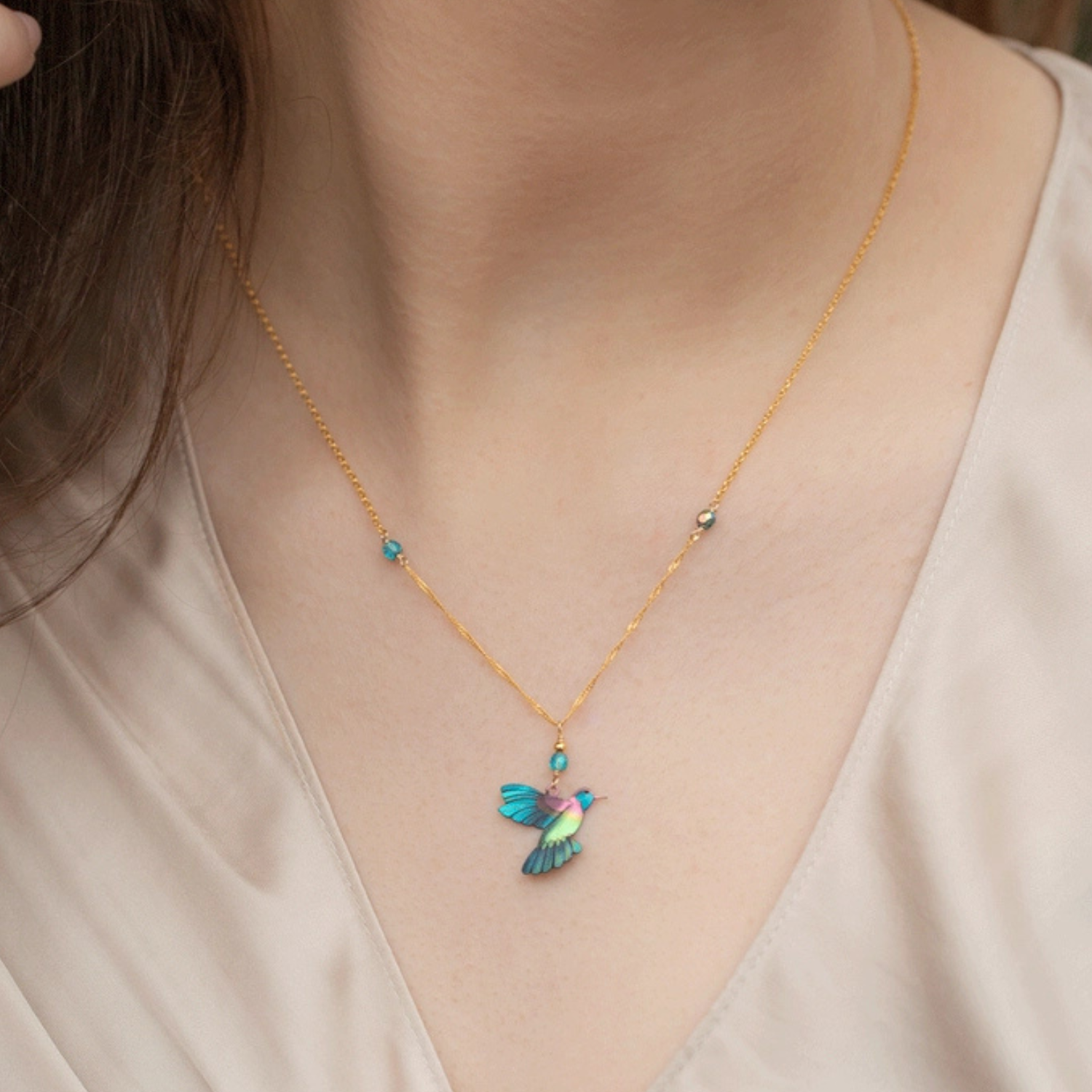 Holly Yashi Picaflor Pendant Necklace showcasing a colorful floral design on a silver chain.