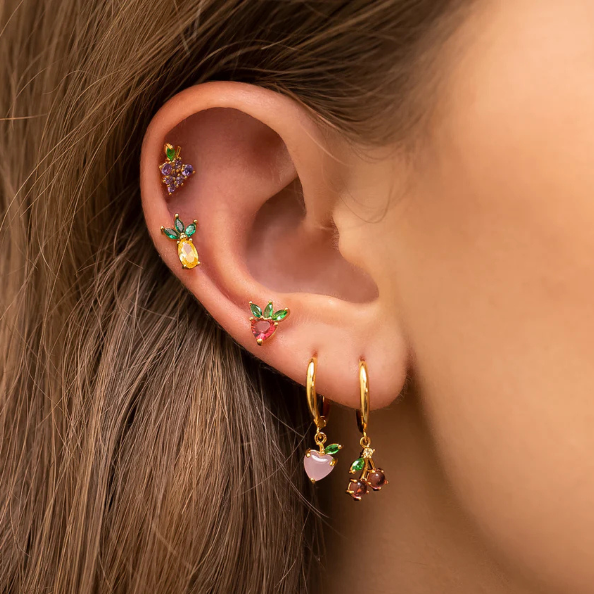 Colorful fruit basket stud earrings by Girls Crew featuring vibrant fruit designs and a playful style.