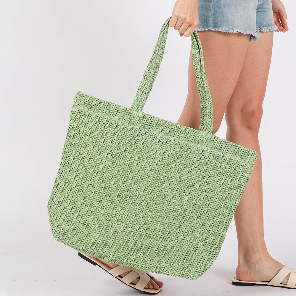 Solid crochet straw tote bag, private label beach handbag with woven design and sturdy handles for casual summer outings.