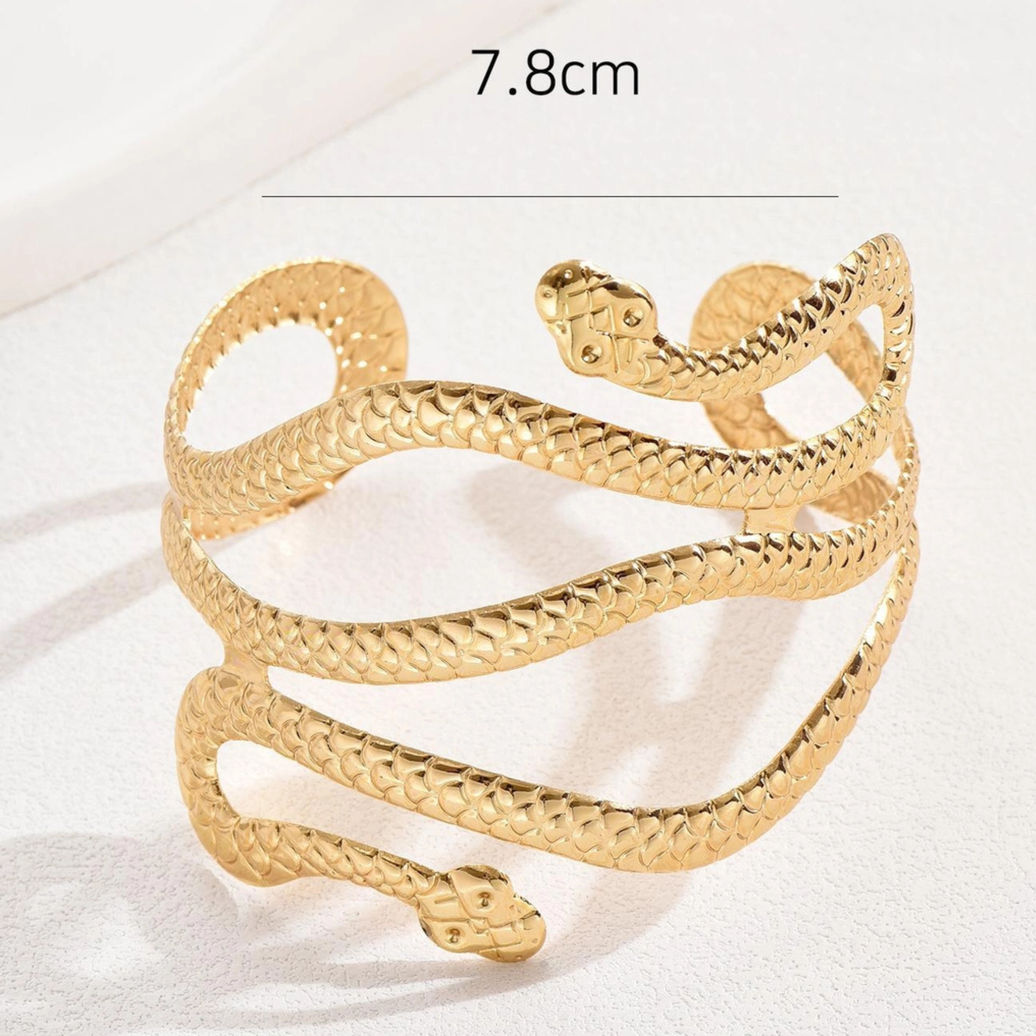 Private label snake wrap arm cuff bracelet featuring a sleek, silver-toned serpent design on a stylish metal band.