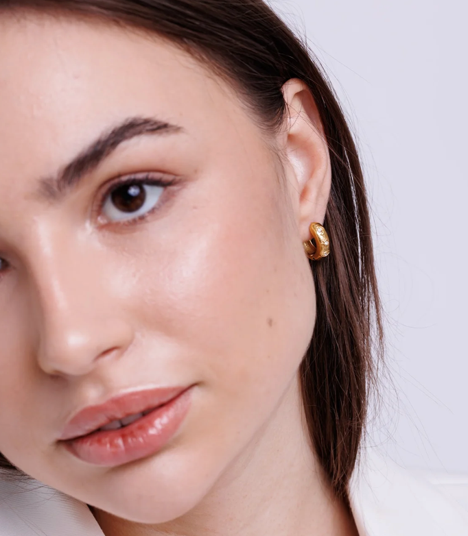 Chubby hoop earrings featuring an evil eye design, adorned with CZ stones, crafted in waterproof 18K gold PVD.