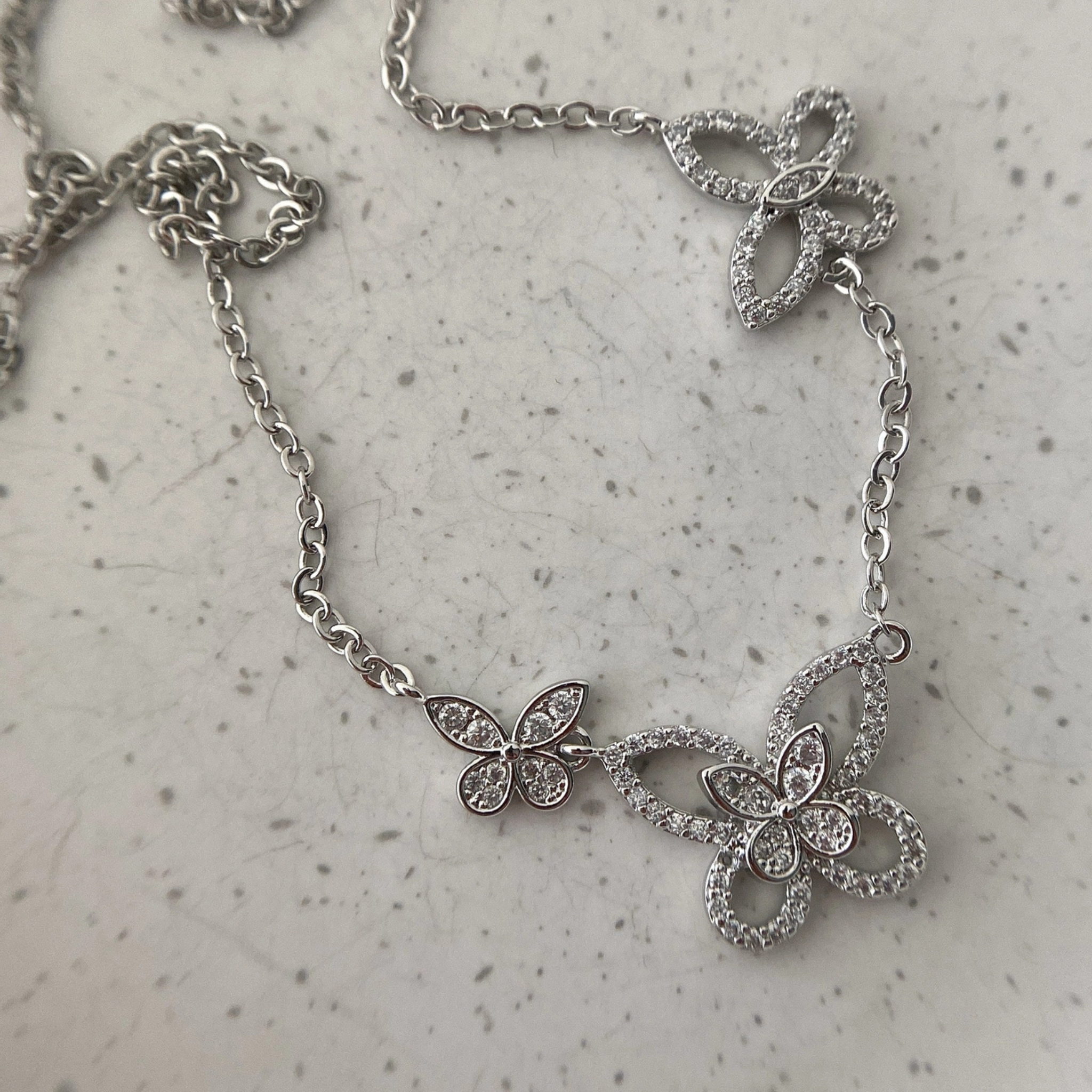 Private label Butterfly Dance Necklace with delicate butterfly pendant on a silver chain, showcasing elegant jewelry design.
