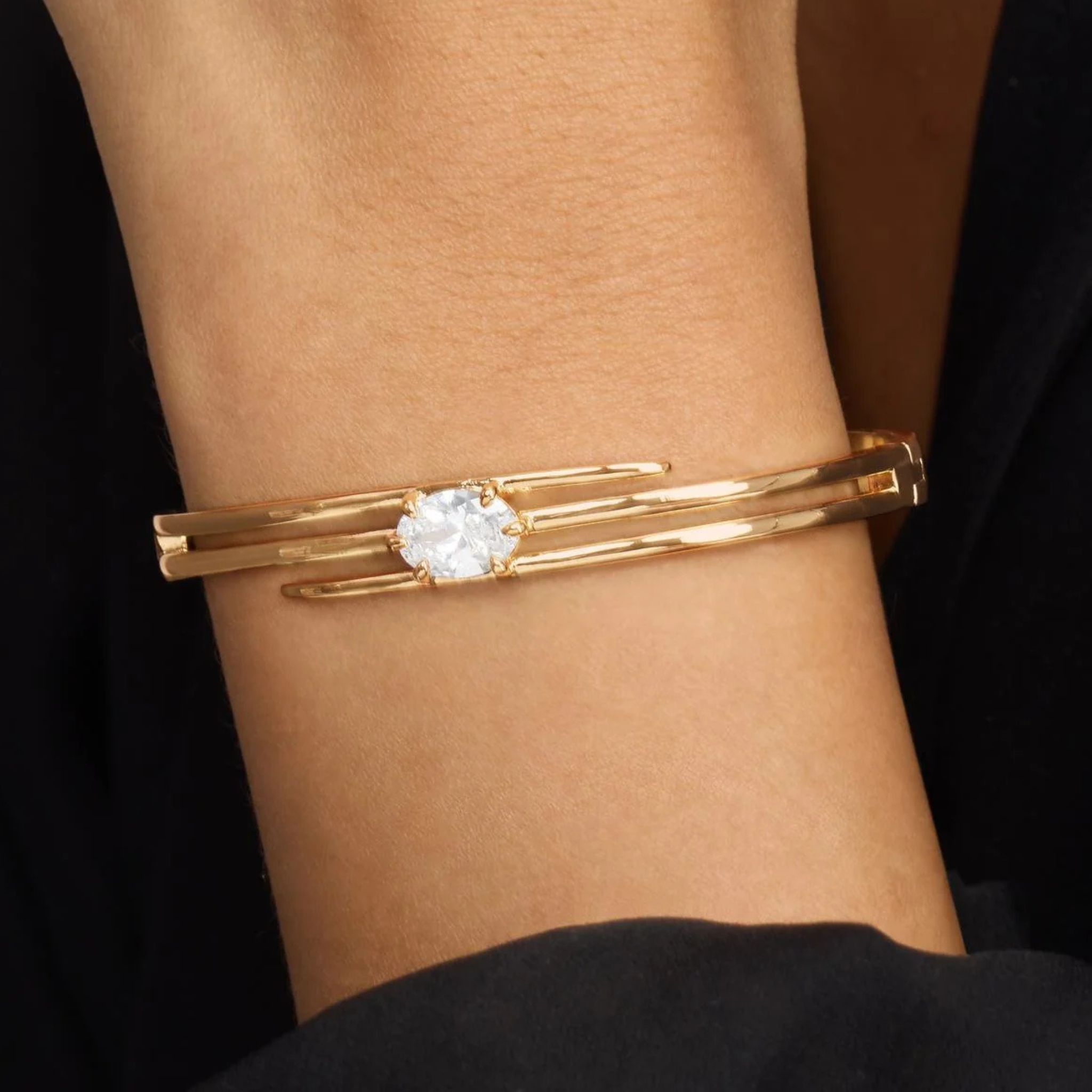 Melinda Maria She's On Point Lasso Cuff bracelet featuring a sleek, gold-tone design with a modern, minimalist aesthetic.
