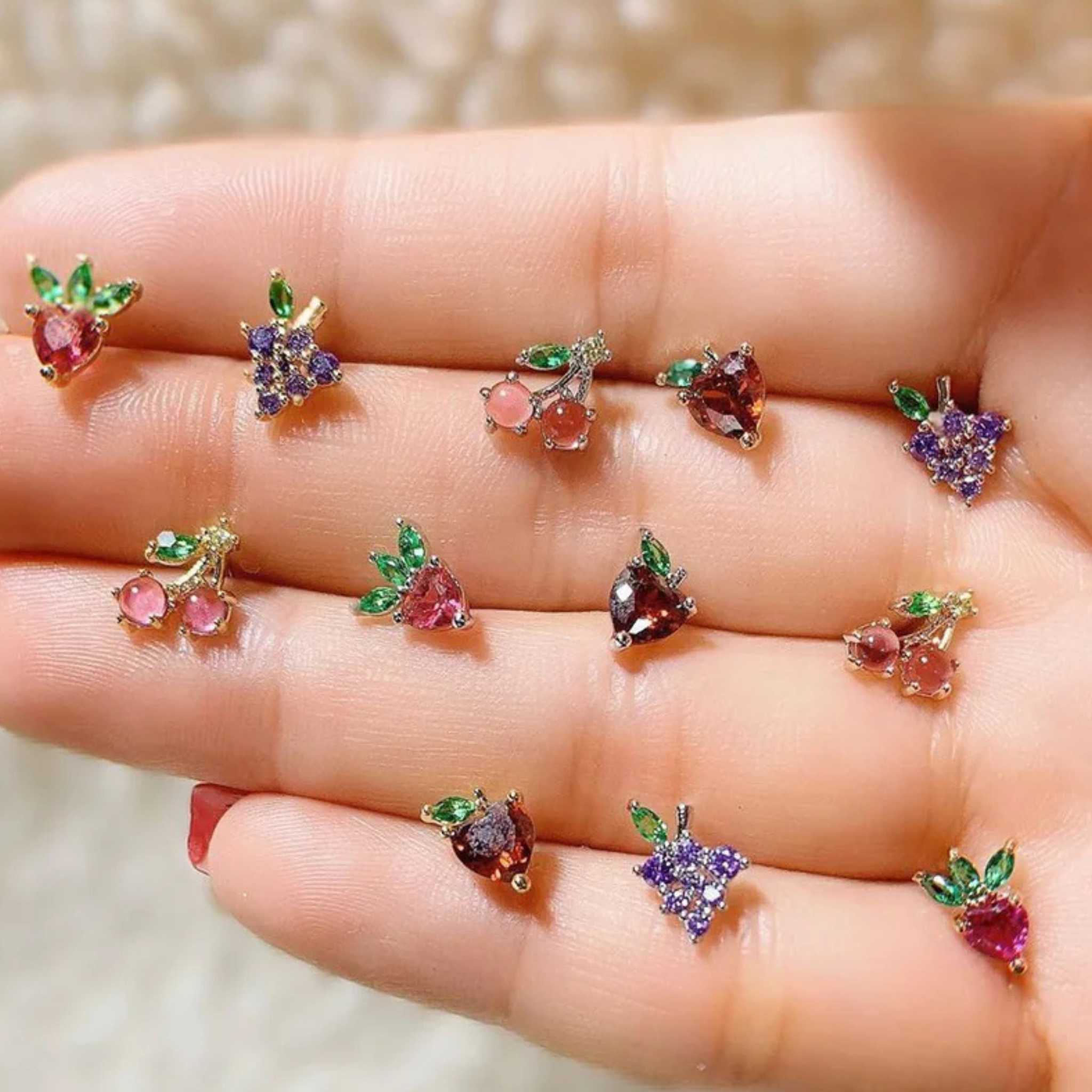 Girls Crew fruit basket stud earrings set featuring colorful fruit designs on a gold-tone base.
