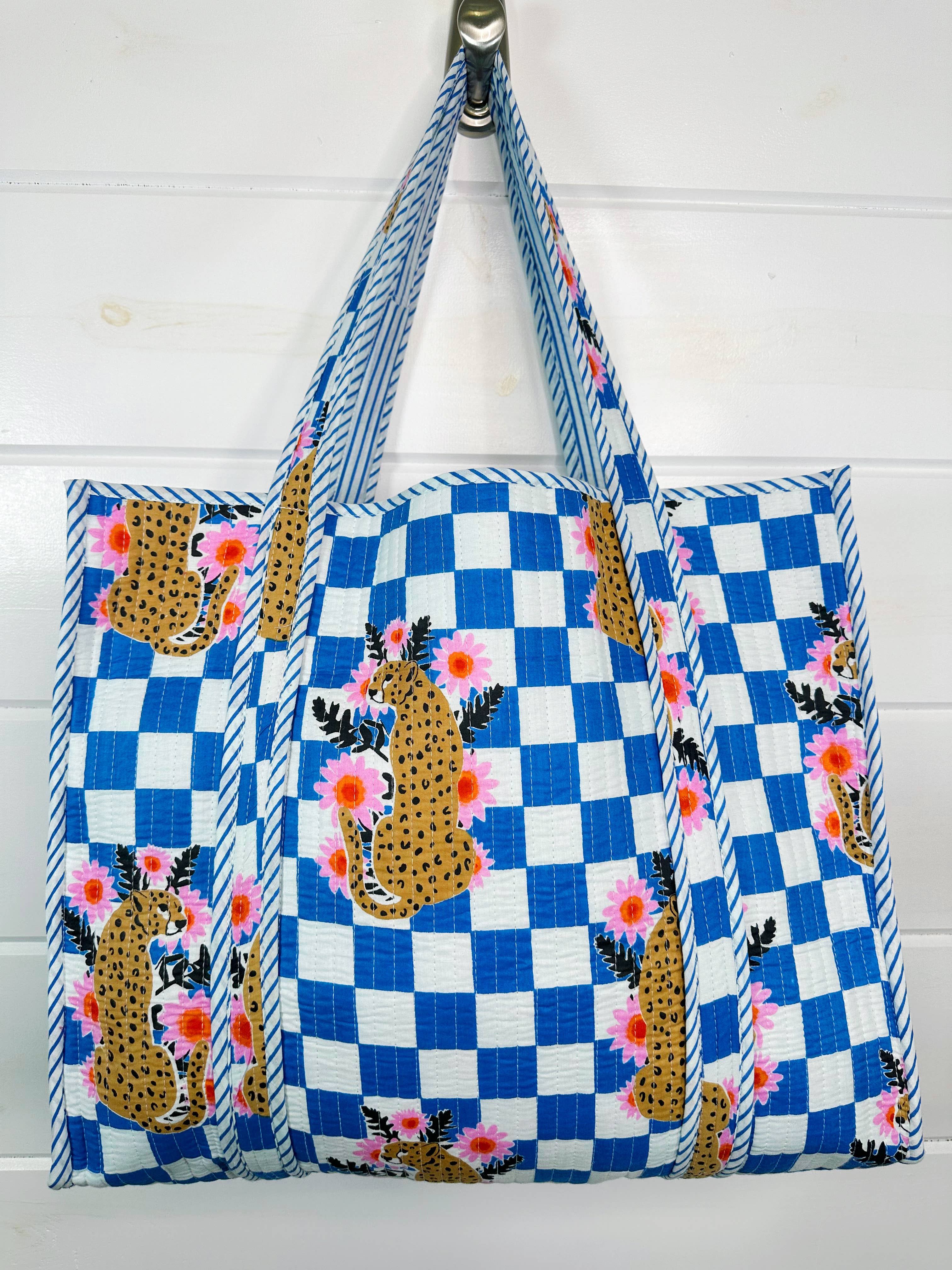 Large Folklore Couture quilted tote bag with jaguar print, stylish shopping tote with sturdy handles and spacious interior.