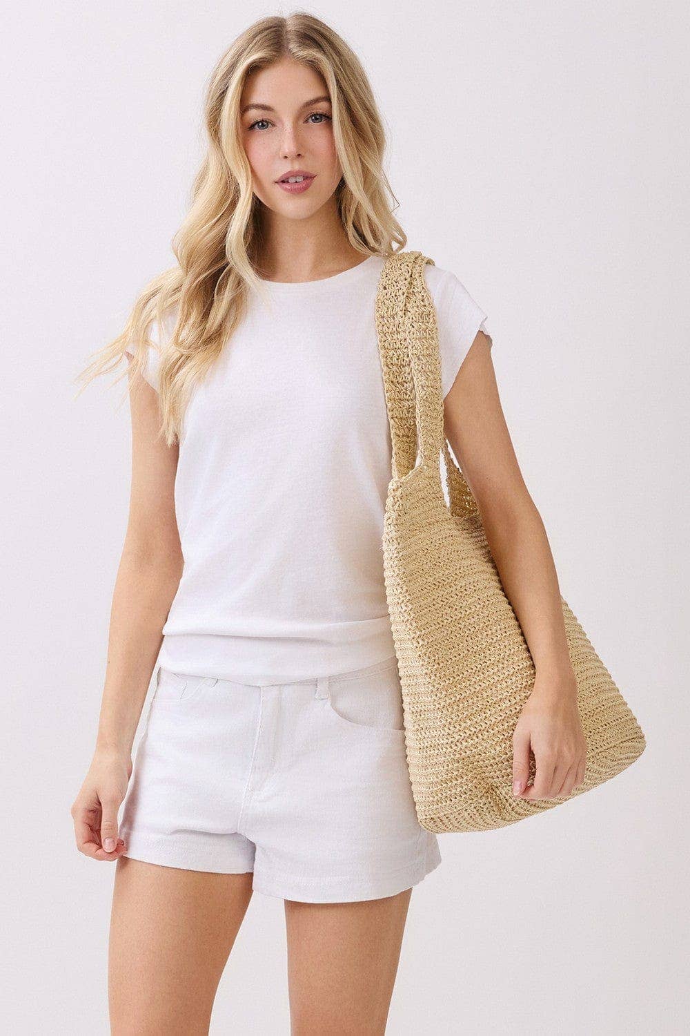 Handmade straw tote bag with leather handles from Private Label, featuring a natural woven straw design for casual everyday use.