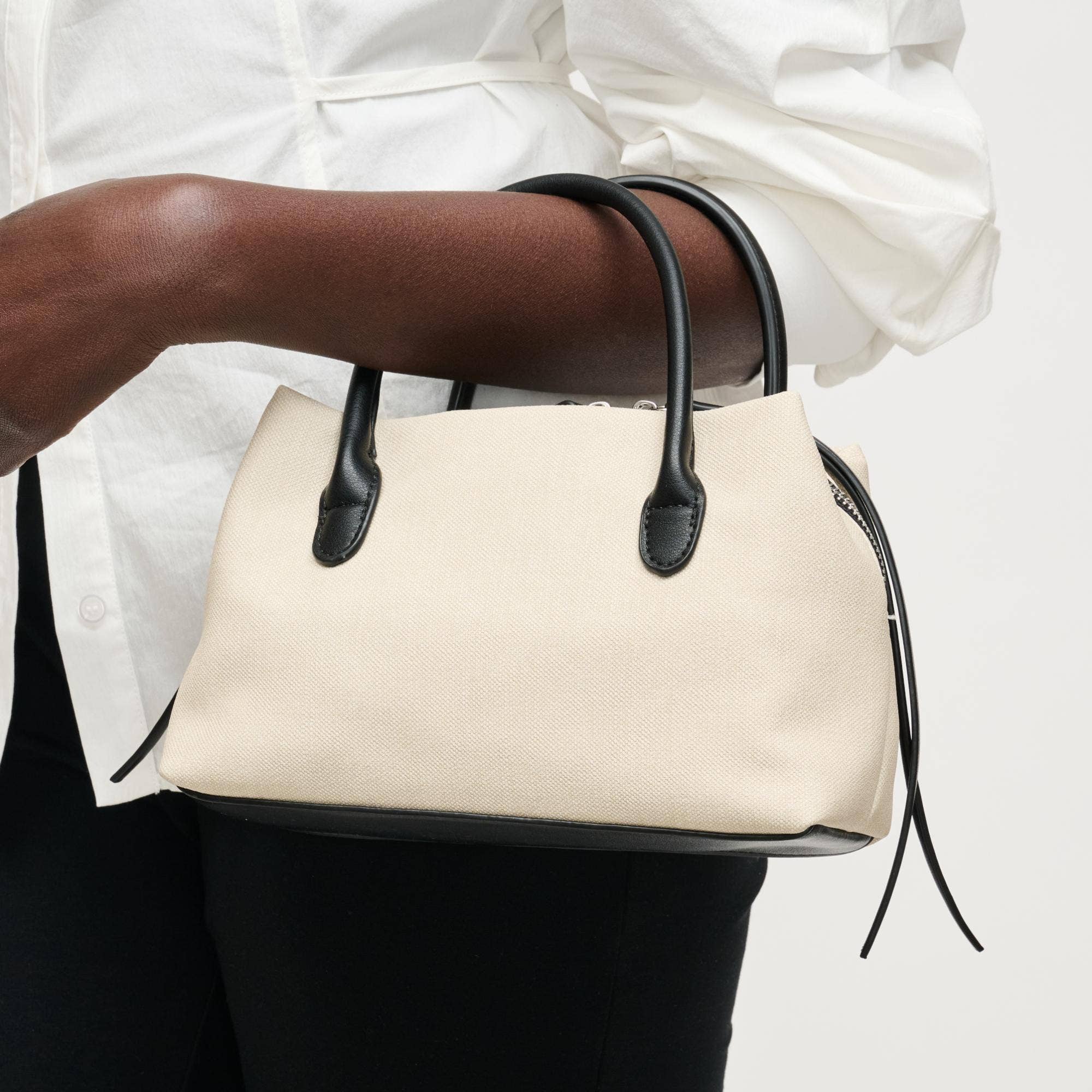 Urban Expressions Logan Crossbody bag with adjustable strap and multiple compartments, shown in black leather.