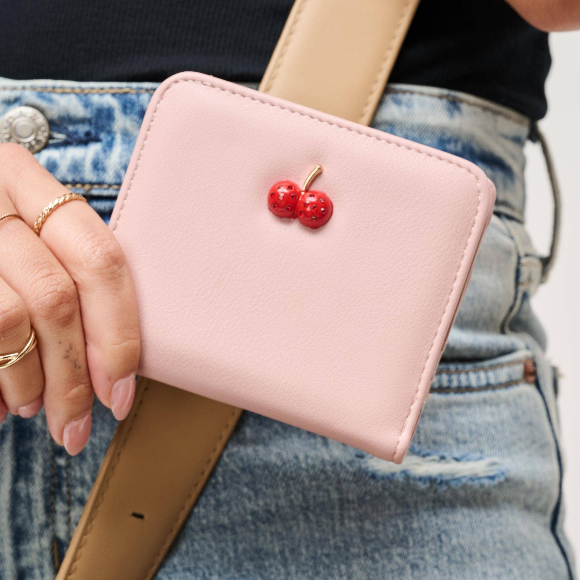 Urban Expressions Lucy Wallet in black with a sleek design, featuring a zip closure and multiple card slots.