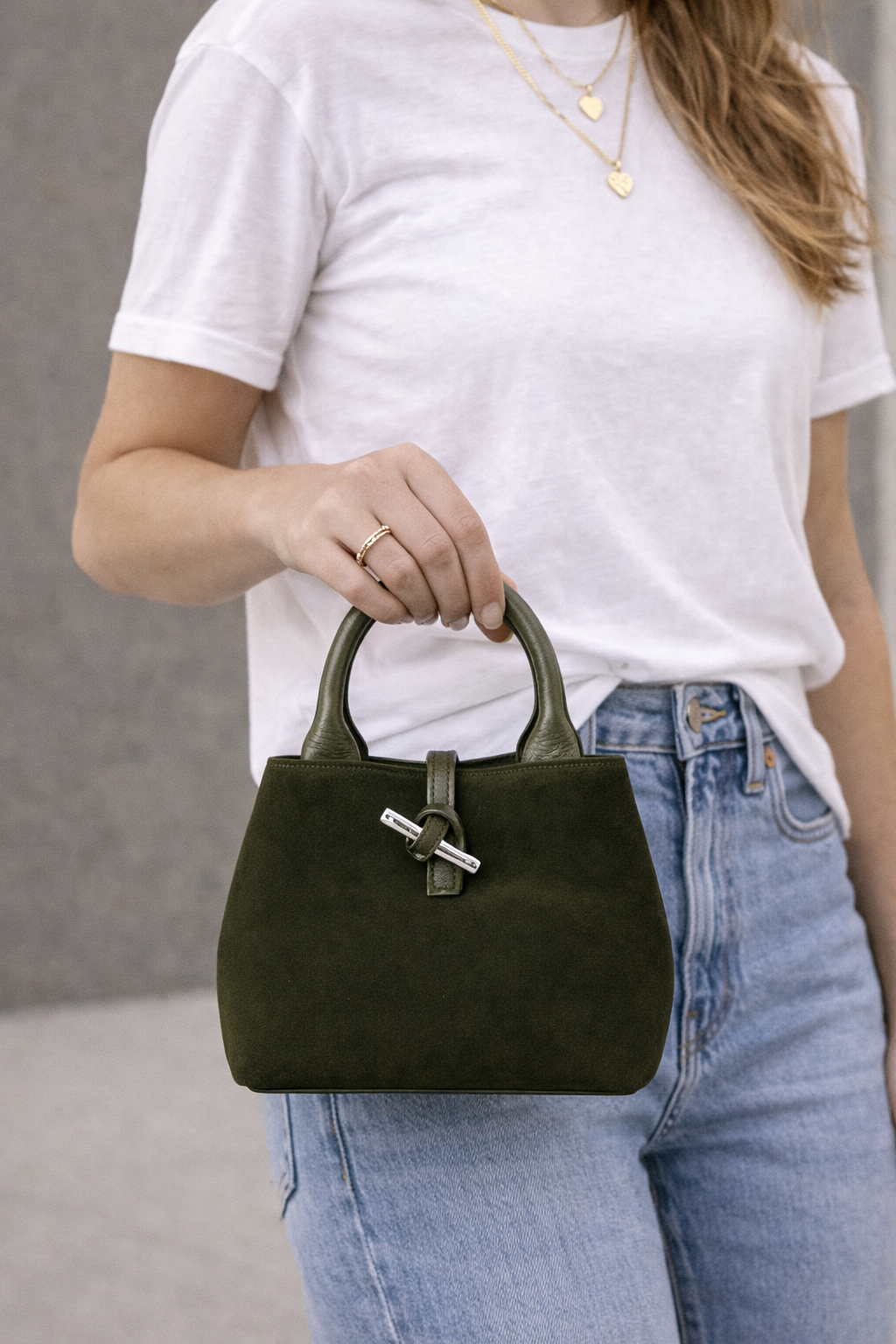 Suede bag named The Italy by private label, featuring a sleek design with a top handle and minimalist style.