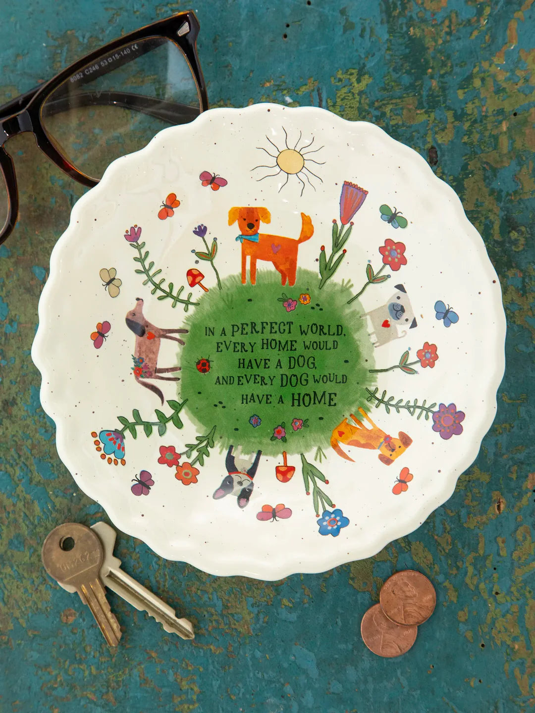 Decorative plate with animal illustrations and text on a textured surface