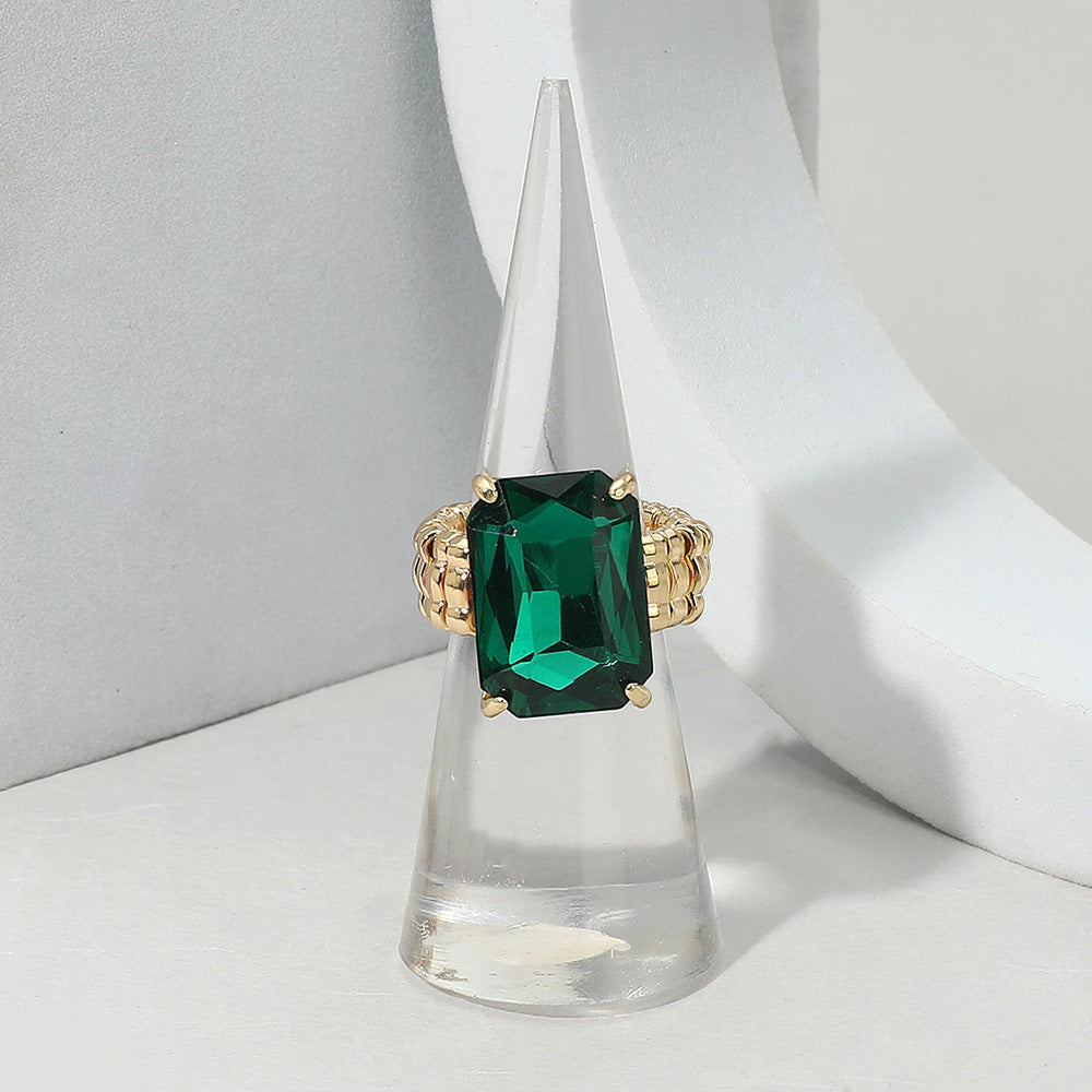 Faceted emerald cut stone cluster stretch ring by Private Label Jewelry showing multiple sparkling stones on a sleek silver band.