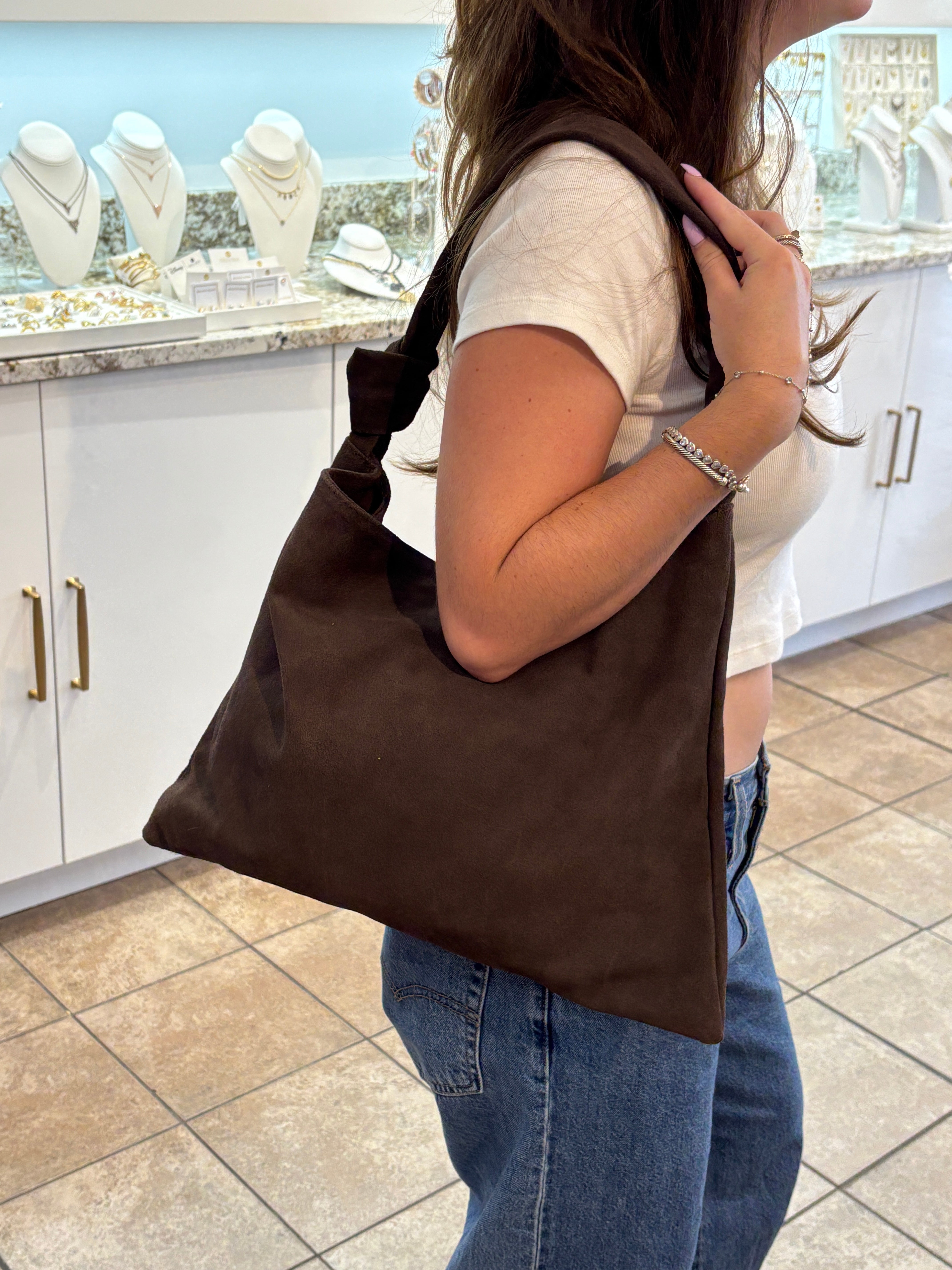 Leena double knot suede shoulder bag in a stylish design with a soft texture and elegant knots on the straps.