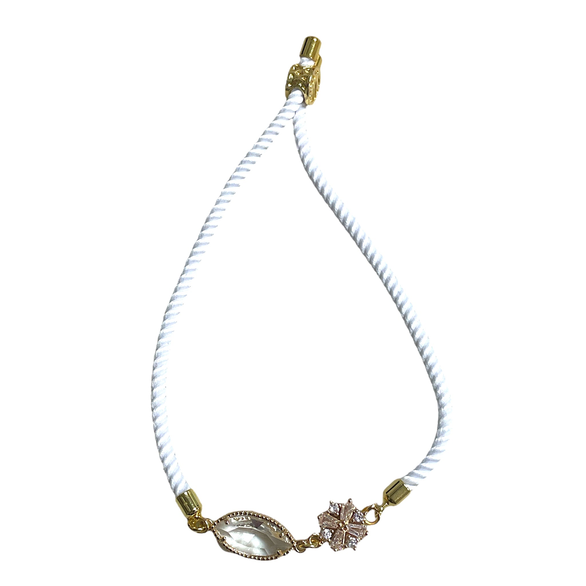 Brenda Perruzza Jewelry rope pulley bracelet with layered black and beige cords and silver accents on a white background.