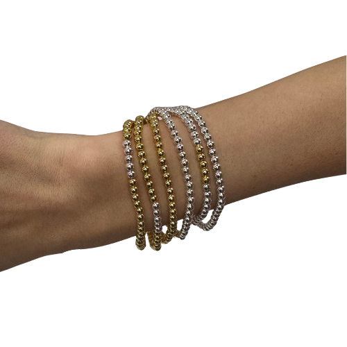 Set of 6 gold and silver combo bracelets by The Skylar Project on a pink and white background.