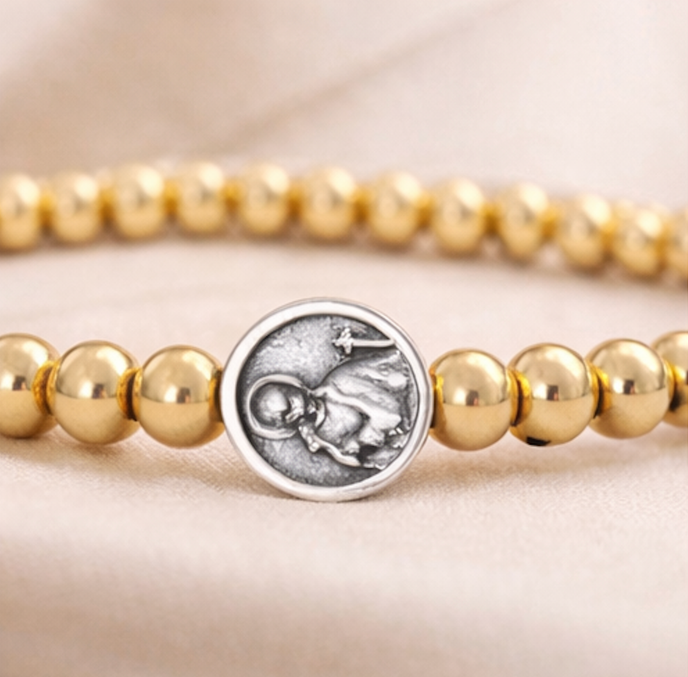 Subliminal Saint Gerard beaded bracelet by love lisa featuring colorful beads and a charm for spiritual connection.