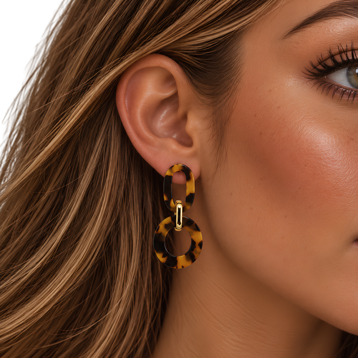 Tortoise shell earrings from Private Label featuring classic oval-shaped design with a glossy finish and gold-tone accents.
