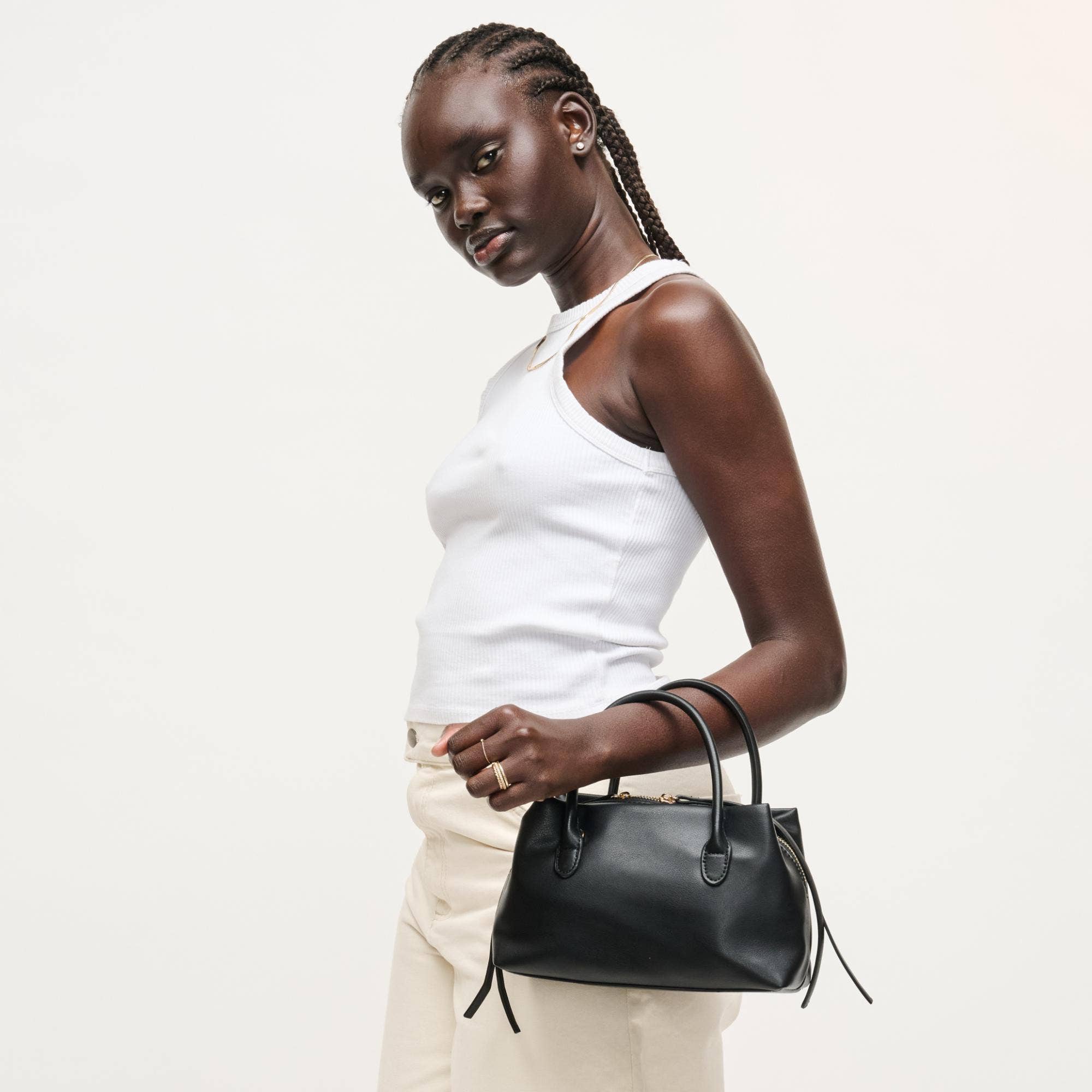 Urban Expressions Logan Crossbody bag with adjustable strap, stylish black leather design, and gold-tone hardware.