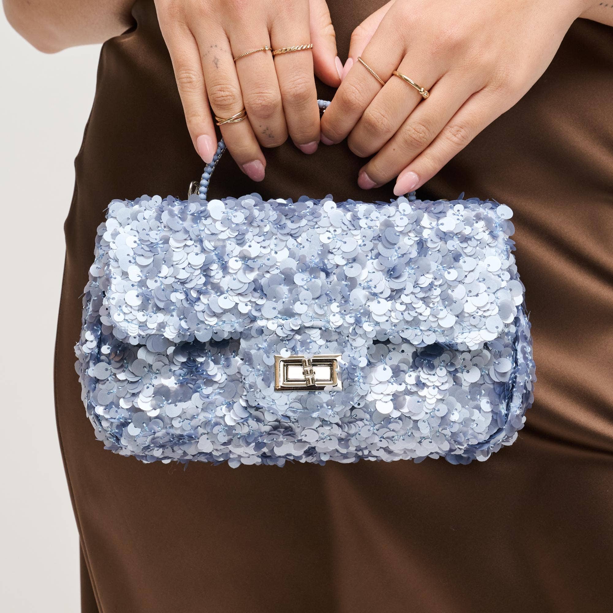 Urban Expressions Ella evening bag with sleek design, featuring a black satin finish and elegant gold chain strap.