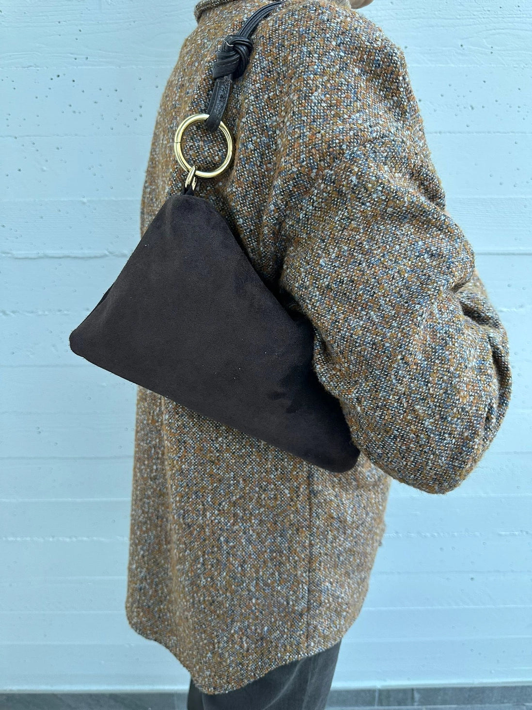 Suede knotted-handle shoulder bag in neutral tones, stylish handbag with a plush texture and elegant design.