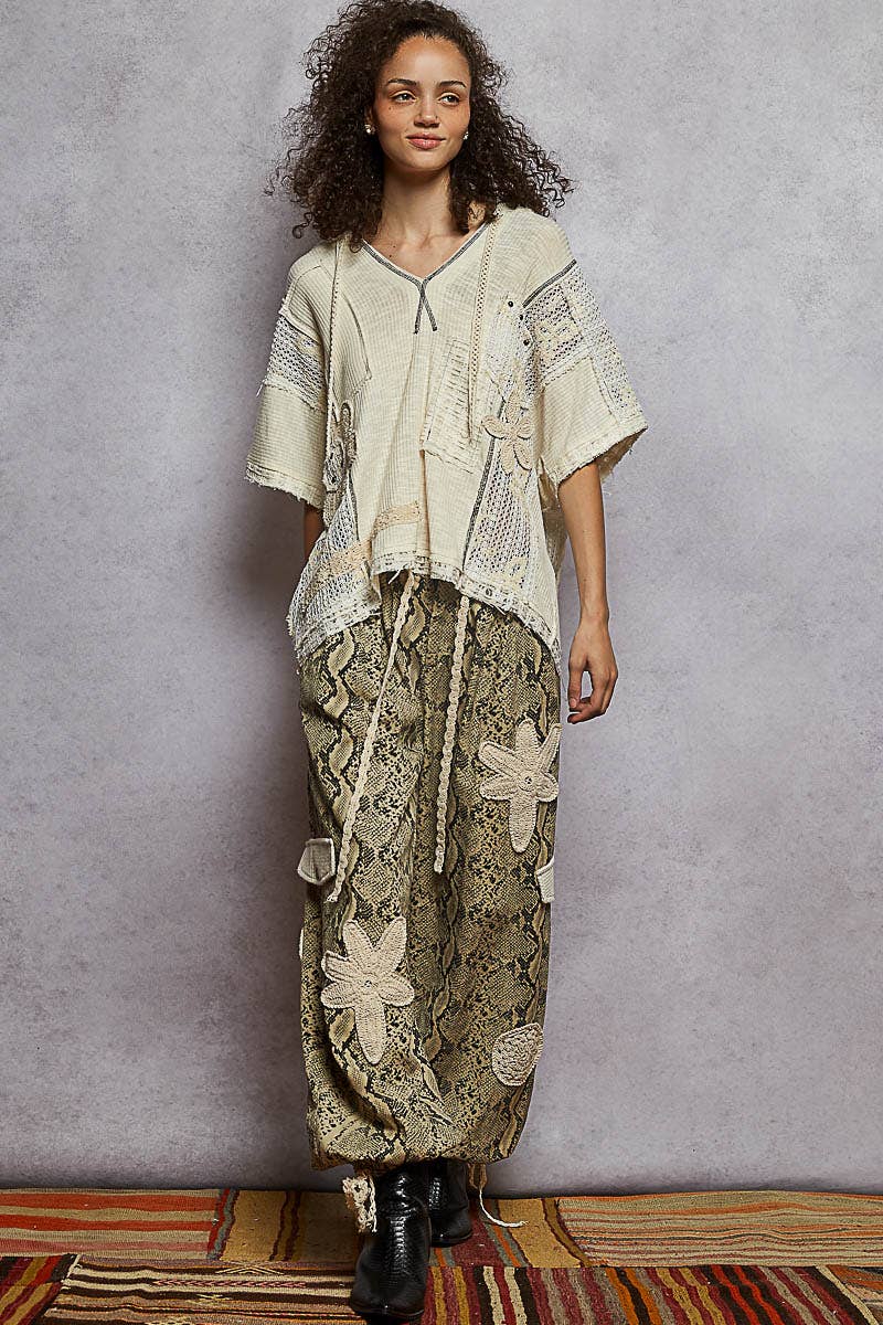 Pol Clothing pleat detail floral patchwork cargo pants with multiple pockets and relaxed fit, showcasing floral and pleat design elements.