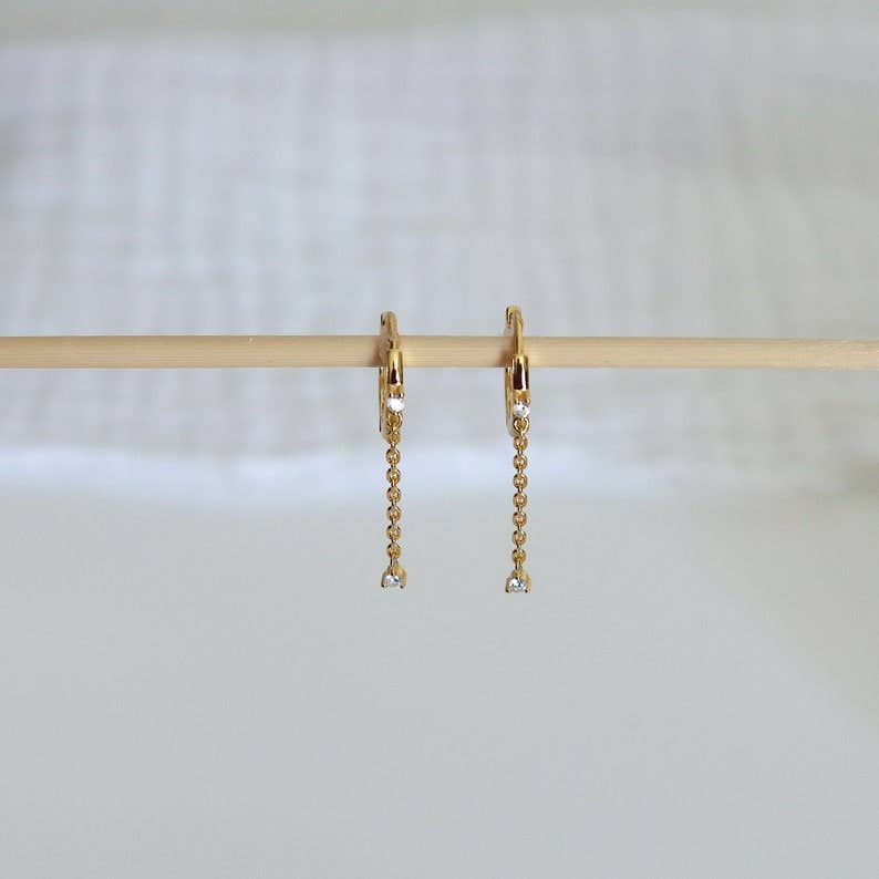 HoopLa huggie drop hoop earrings with chain, gold-tone jewelry featuring small hoop design and dangling chain detail.