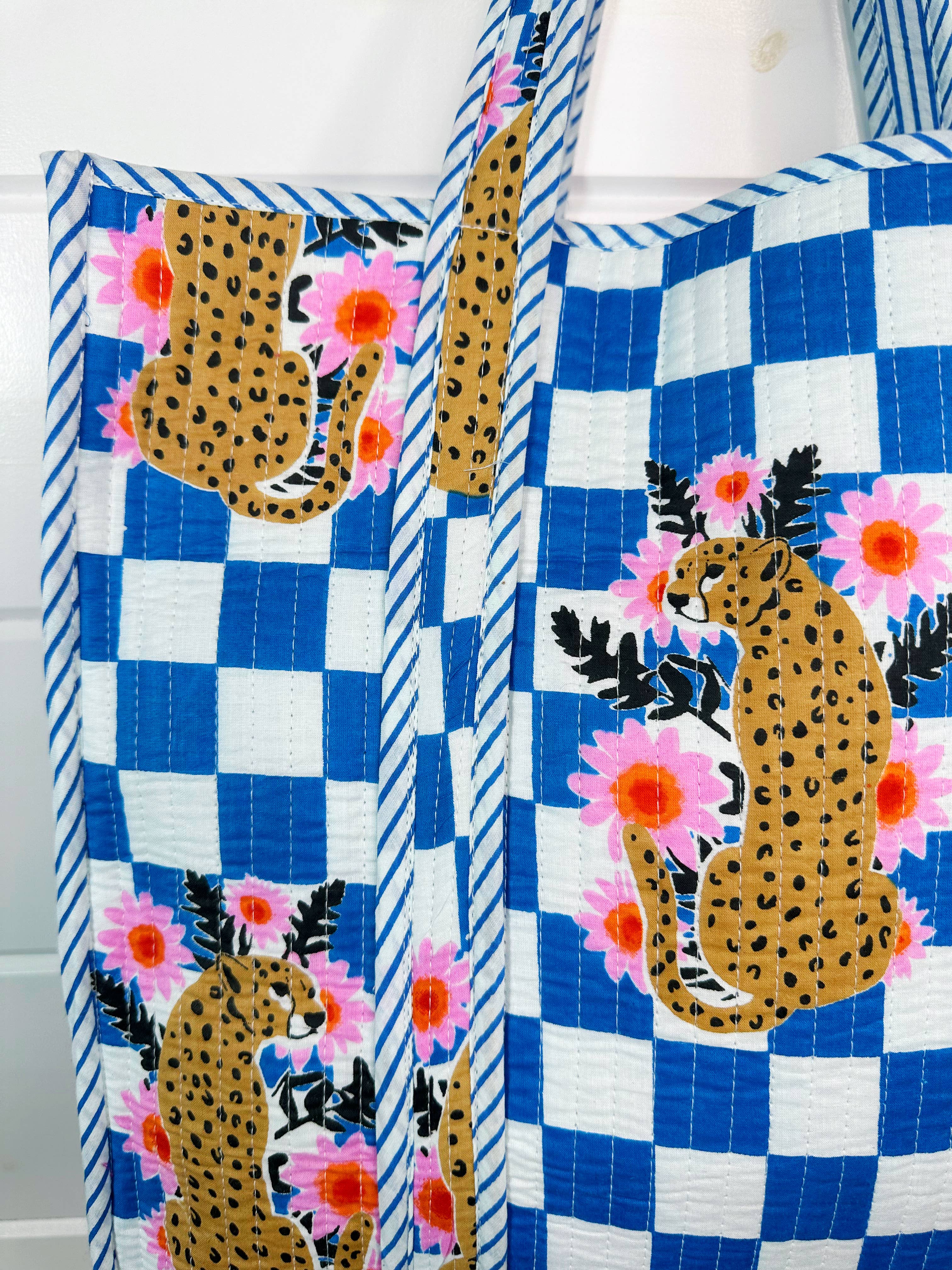 Large Folklore Couture quilted tote bag with jaguar print, featuring sturdy handles and spacious interior for shopping or daily use.