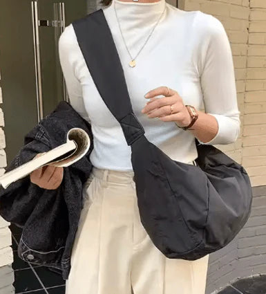 Black Cana Crescent Crossbody bag by prenelove, featuring a crescent shape and adjustable strap for stylish convenience.