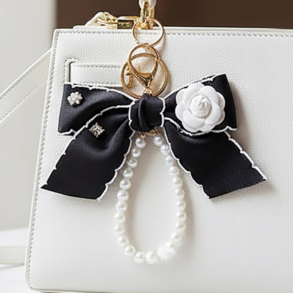 Flower rhinestone accent pearl loop bow keychain bag charm with decorative details, perfect for accessories and bags.