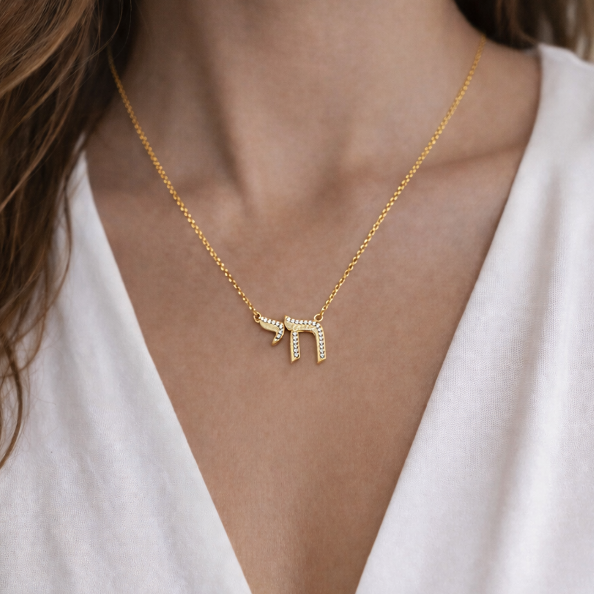 Private label Chai Cz outline necklace with heart and bow charm, featuring delicate silver chain and intricate design.